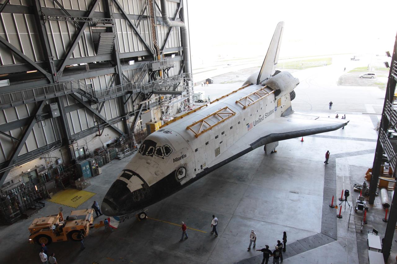 CAPE CANAVERAL, Fla. - Space shuttle Atlantis arrives in High Bay 4 of the Vehicle Assembly Building as technicians complete the tow from Orbiter Processing Facility Bay 1 at NASA's Kennedy Space Center.    The work is part of the Space Shuttle Program's transition and retirement processing of the space shuttle fleet. A groundbreaking was held Jan. 18 for Atlantis' future home, a 65,000-square-foot exhibit hall in Shuttle Plaza at the Kennedy Space Center Visitor Complex. Atlantis is scheduled to roll over to the visitor complex in November in preparation for the exhibit's grand opening in July 2013. For more information, visit http://www.nasa.gov/transition. Photo credit: NASA/Jim Grossmann