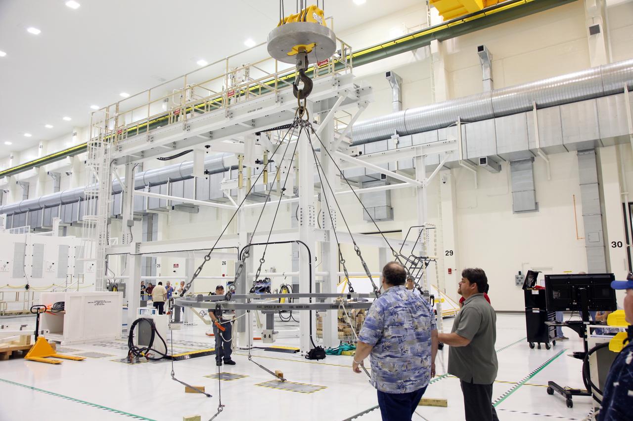 CAPE CANAVERAL, Fla. - Inside the Operations and Checkout Building high bay at NASA's Kennedy Space Center in Florida, technicians prepare a lifting ring to support the arrival of the Orion crew module.    Slated for Exploration Flight Test-1, an uncrewed mission planned for 2014, the capsule will travel farther into space than any human spacecraft has gone in more than 40 years. NASA's Michoud Assembly Facility in New Orleans built the crew module pressure vessel. The Orion production team will prepare the module for flight by installing heat-shielding thermal protection systems, avionics and other subsystems. For more information, visit http://www.nasa.gov/orion.  Photo credit: NASA/Gianni Woods