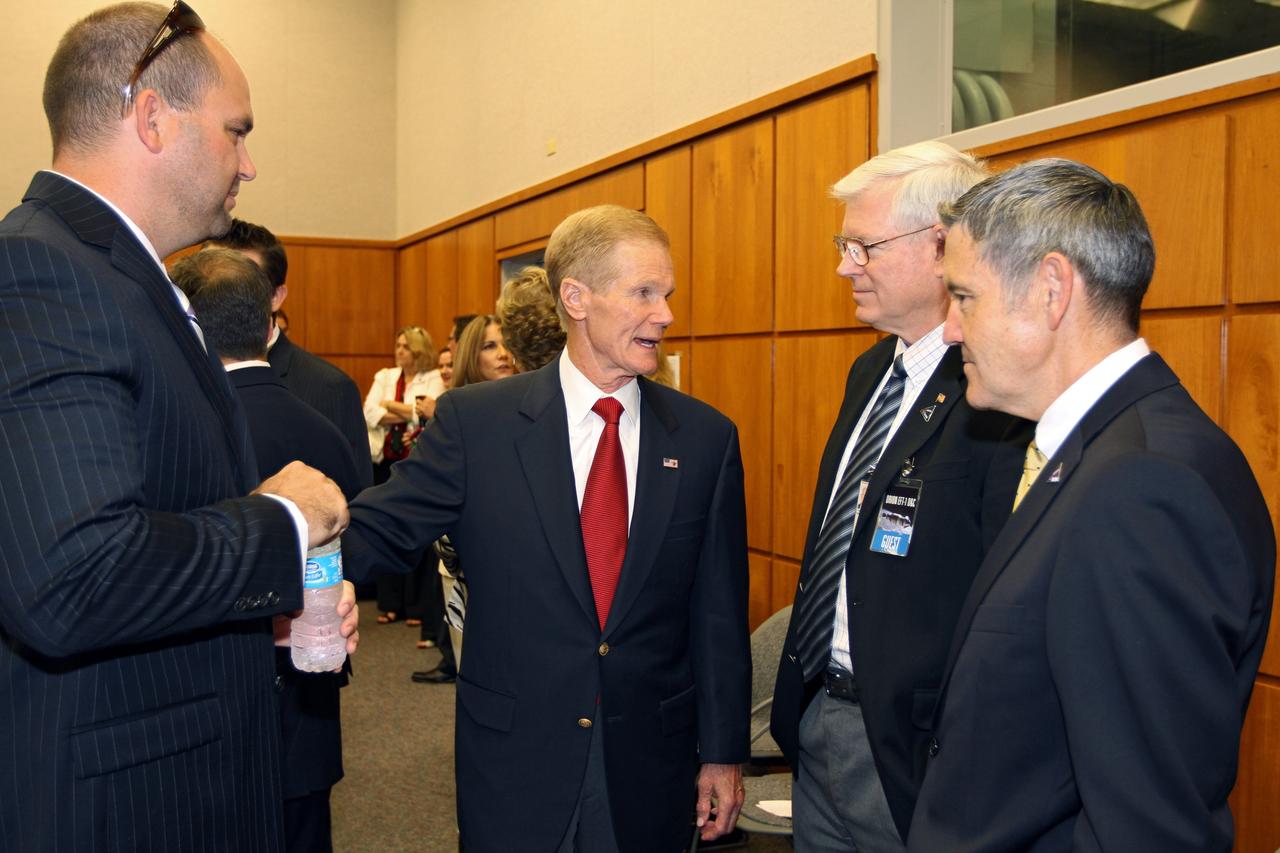 CAPE CANAVERAL, Fla. – Dignitaries turn out for an event marking the arrival of NASA's first space-bound Orion capsule at NASA's Kennedy Space Center in Florida.  In Kennedy's Operations and Checkout Building Mission Briefing Room are, from left, Nicholas Cummings, chief of Operations Integration, Ground Systems Development and Operations Program U.S. Senator Bill Nelson Johnson Space Center Director Michael Coats and Kennedy Space Center Director Robert Cabana.    Slated for Exploration Flight Test-1, an uncrewed mission planned for 2014, the capsule will travel farther into space than any human spacecraft has gone in more than 40 years. The capsule was shipped to Kennedy from NASA's Michoud Assembly Facility in New Orleans where the crew module pressure vessel was built. The Orion production team will prepare the module for flight at Kennedy by installing heat-shielding thermal protection systems, avionics and other subsystems. For more information, visit http://www.nasa.gov/orion.  Photo credit: NASA/Kim Shiflett