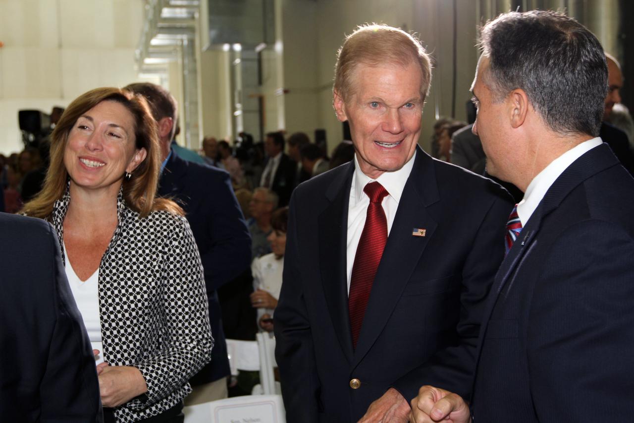 CAPE CANAVERAL, Fla. – NASA Deputy Director Lori Garver, left, visits NASA's Kennedy Space Center in Florida to participate in an event marking the arrival of NASA's first space-bound Orion capsule at Kennedy.  With Garver in Kennedy's Operations and Checkout Building high bay are, from left, U.S. Senator Bill Nelson and Trent Smith, NASA project engineer.    Slated for Exploration Flight Test-1, an uncrewed mission planned for 2014, the capsule will travel farther into space than any human spacecraft has gone in more than 40 years. The capsule was shipped to Kennedy from NASA's Michoud Assembly Facility in New Orleans where the crew module pressure vessel was built. The Orion production team will prepare the module for flight at Kennedy by installing heat-shielding thermal protection systems, avionics and other subsystems. For more information, visit http://www.nasa.gov/orion.  Photo credit: NASA/Kim Shiflett