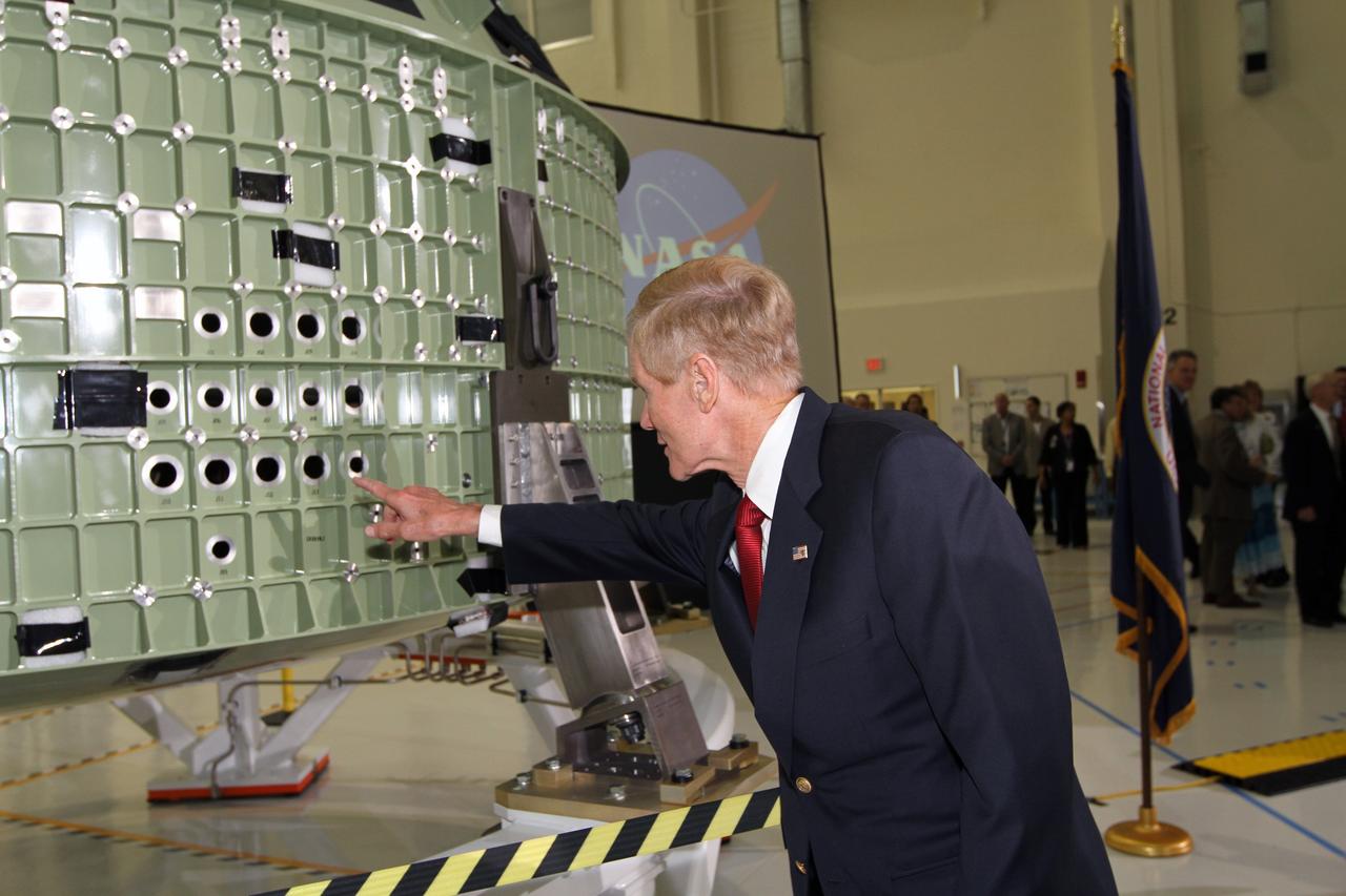 CAPE CANAVERAL, Fla. – U.S. Senator Bill Nelson checks out NASA's first space-bound Orion capsule at NASA's Kennedy Space Center in Florida. Nelson and the spacecraft are in Kennedy's Operations and Checkout Building high bay for an event marking its arrival at Kennedy.    Slated for Exploration Flight Test-1, an uncrewed mission planned for 2014, the capsule will travel farther into space than any human spacecraft has gone in more than 40 years. The capsule was shipped to Kennedy from NASA's Michoud Assembly Facility in New Orleans where the crew module pressure vessel was built. The Orion production team will prepare the module for flight at Kennedy by installing heat-shielding thermal protection systems, avionics and other subsystems. For more information, visit http://www.nasa.gov/orion.  Photo credit: NASA/Kim Shiflett