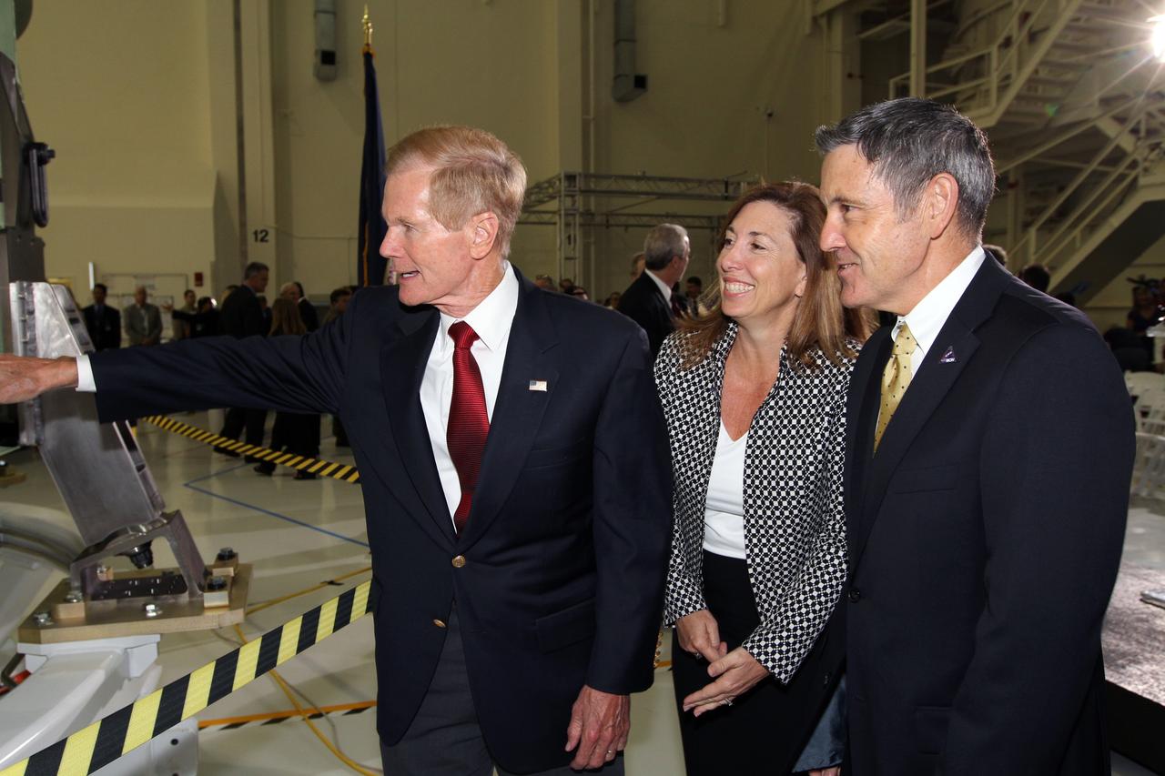 CAPE CANAVERAL, Fla. – U.S. Senator Bill Nelson, left, checks out NASA's first space-bound Orion capsule at NASA's Kennedy Space Center in Florida. With Nelson in Kennedy's Operations and Checkout Building high bay for an event marking the spacecraft's arrival at Kennedy are NASA Deputy Director Lori Garver and Kennedy Director Robert Cabana.    Slated for Exploration Flight Test-1, an uncrewed mission planned for 2014, the capsule will travel farther into space than any human spacecraft has gone in more than 40 years. The capsule was shipped to Kennedy from NASA's Michoud Assembly Facility in New Orleans where the crew module pressure vessel was built. The Orion production team will prepare the module for flight at Kennedy by installing heat-shielding thermal protection systems, avionics and other subsystems. For more information, visit http://www.nasa.gov/orion.  Photo credit: NASA/Kim Shiflett