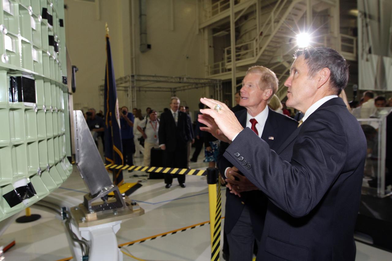 CAPE CANAVERAL, Fla. – U.S. Senator Bill Nelson, left, and NASA Kennedy Space Center Director Robert Cabana inspect NASA's first space-bound Orion capsule in Kennedy's Operations and Checkout Building high bay following an event marking the spacecraft's arrival in Florida.    Slated for Exploration Flight Test-1, an uncrewed mission planned for 2014, the capsule will travel farther into space than any human spacecraft has gone in more than 40 years. The capsule was shipped to Kennedy from NASA's Michoud Assembly Facility in New Orleans where the crew module pressure vessel was built. The Orion production team will prepare the module for flight at Kennedy by installing heat-shielding thermal protection systems, avionics and other subsystems. For more information, visit http://www.nasa.gov/orion.  Photo credit: NASA/Kim Shiflett