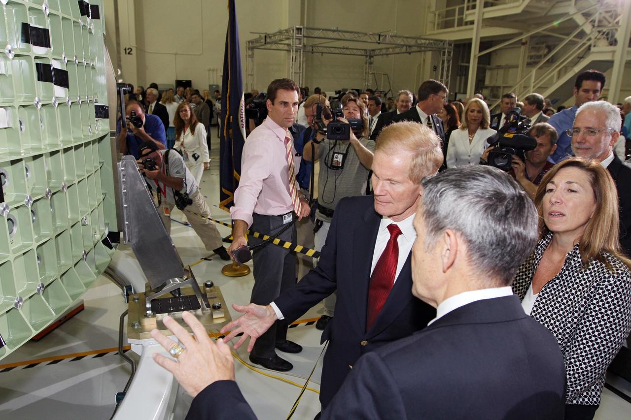 CAPE CANAVERAL, Fla. – From left, U.S. Senator Bill Nelson, NASA Kennedy Space Center Director Robert Cabana and NASA Deputy Director Lori Garver discuss NASA's first space-bound Orion capsule in Kennedy's Operations and Checkout Building high bay following an event marking the spacecraft's arrival in Florida.    Slated for Exploration Flight Test-1, an uncrewed mission planned for 2014, the capsule will travel farther into space than any human spacecraft has gone in more than 40 years. The capsule was shipped to Kennedy from NASA's Michoud Assembly Facility in New Orleans where the crew module pressure vessel was built. The Orion production team will prepare the module for flight at Kennedy by installing heat-shielding thermal protection systems, avionics and other subsystems. For more information, visit http://www.nasa.gov/orion.  Photo credit: NASA/Kim Shiflett