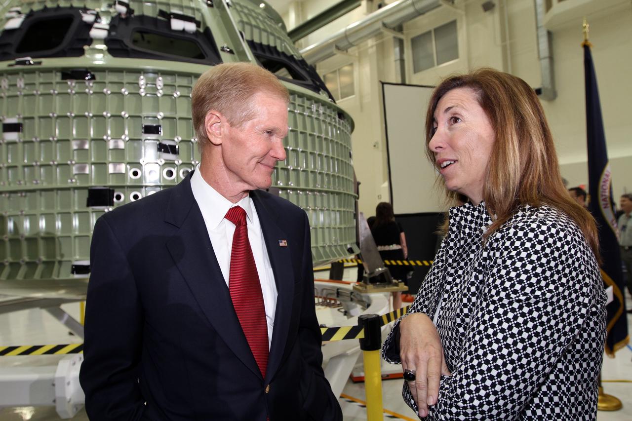 CAPE CANAVERAL, Fla. – U.S. Senator Bill Nelson, left, and NASA Deputy Director Lori Garver discuss NASA's first space-bound Orion capsule in Kennedy Space Center's Operations and Checkout Building high bay following an event marking the spacecraft's arrival in Florida.    Slated for Exploration Flight Test-1, an uncrewed mission planned for 2014, the capsule will travel farther into space than any human spacecraft has gone in more than 40 years. The capsule was shipped to Kennedy from NASA's Michoud Assembly Facility in New Orleans where the crew module pressure vessel was built. The Orion production team will prepare the module for flight at Kennedy by installing heat-shielding thermal protection systems, avionics and other subsystems. For more information, visit http://www.nasa.gov/orion.  Photo credit: NASA/Kim Shiflett