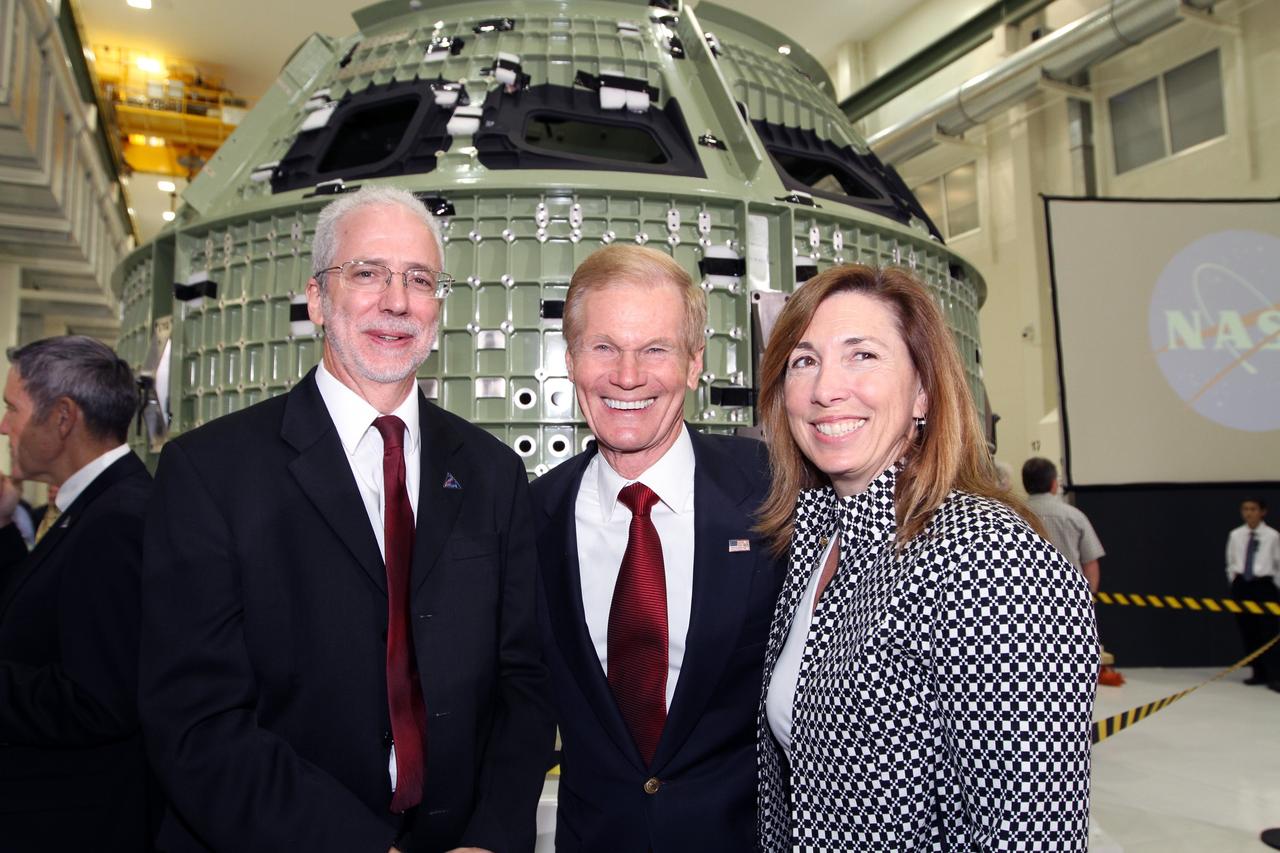 CAPE CANAVERAL, Fla. – From left, Orion Program Manager Mark Geyer, U.S. Senator Bill Nelson and NASA Deputy Director Lori Garver pose for a portrait in front of NASA's first space-bound Orion capsule in Kennedy Space Center's Operations and Checkout Building high bay following an event marking the spacecraft's arrival in Florida.    Slated for Exploration Flight Test-1, an uncrewed mission planned for 2014, the capsule will travel farther into space than any human spacecraft has gone in more than 40 years. The capsule was shipped to Kennedy from NASA's Michoud Assembly Facility in New Orleans where the crew module pressure vessel was built. The Orion production team will prepare the module for flight at Kennedy by installing heat-shielding thermal protection systems, avionics and other subsystems. For more information, visit http://www.nasa.gov/orion.  Photo credit: NASA/Kim Shiflett