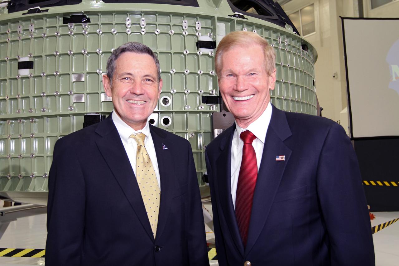 CAPE CANAVERAL, Fla. – From left, Kennedy Space Center Director Robert Cabana and U.S. Senator Bill Nelson pose for a portrait in front of NASA's first space-bound Orion capsule in Kennedy's Operations and Checkout Building high bay following an event marking the spacecraft's arrival in Florida.    Slated for Exploration Flight Test-1, an uncrewed mission planned for 2014, the capsule will travel farther into space than any human spacecraft has gone in more than 40 years. The capsule was shipped to Kennedy from NASA's Michoud Assembly Facility in New Orleans where the crew module pressure vessel was built. The Orion production team will prepare the module for flight at Kennedy by installing heat-shielding thermal protection systems, avionics and other subsystems. For more information, visit http://www.nasa.gov/orion.  Photo credit: NASA/Kim Shiflett