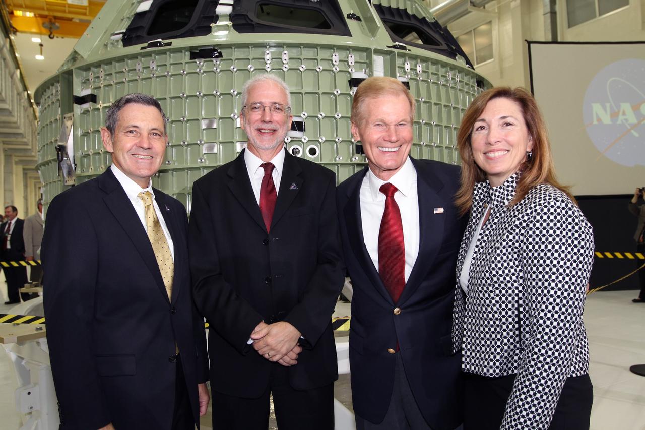 CAPE CANAVERAL, Fla. – From left, Kennedy Space Center Director Robert Cabana, Orion Program Manager Mark Geyer, U.S. Senator Bill Nelson and NASA Deputy Director Lori Garver pose for a portrait in front of NASA's first space-bound Orion capsule in Kennedy's Operations and Checkout Building high bay following an event marking the spacecraft's arrival in Florida.      Slated for Exploration Flight Test-1, an uncrewed mission planned for 2014, the capsule will travel farther into space than any human spacecraft has gone in more than 40 years. The capsule was shipped to Kennedy from NASA's Michoud Assembly Facility in New Orleans where the crew module pressure vessel was built. The Orion production team will prepare the module for flight at Kennedy by installing heat-shielding thermal protection systems, avionics and other subsystems. For more information, visit http://www.nasa.gov/orion.  Photo credit: NASA/Kim Shiflett