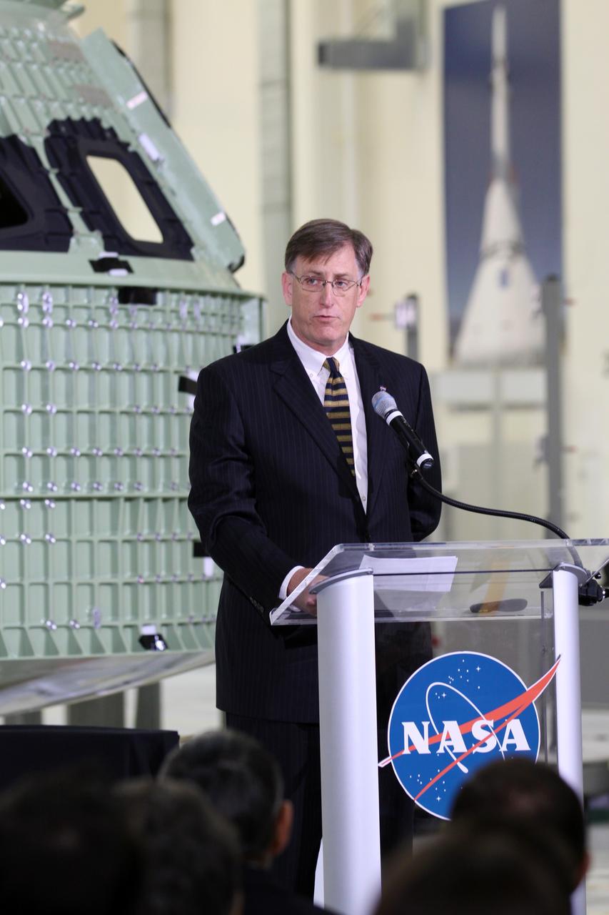 CAPE CANAVERAL, Fla. – Dan Dumbacher, NASA deputy associate administrator for Exploration Systems Development, addresses the audience assembled in Kennedy Space Center's Operations and Checkout Building high bay for an event marking the arrival of NASA's first space-bound Orion capsule in Florida.    Slated for Exploration Flight Test-1, an uncrewed mission planned for 2014, the capsule will travel farther into space than any human spacecraft has gone in more than 40 years. The capsule was shipped to Kennedy from NASA's Michoud Assembly Facility in New Orleans where the crew module pressure vessel was built. The Orion production team will prepare the module for flight at Kennedy by installing heat-shielding thermal protection systems, avionics and other subsystems. For more information, visit http://www.nasa.gov/orion.  Photo credit: NASA/Kim Shiflett