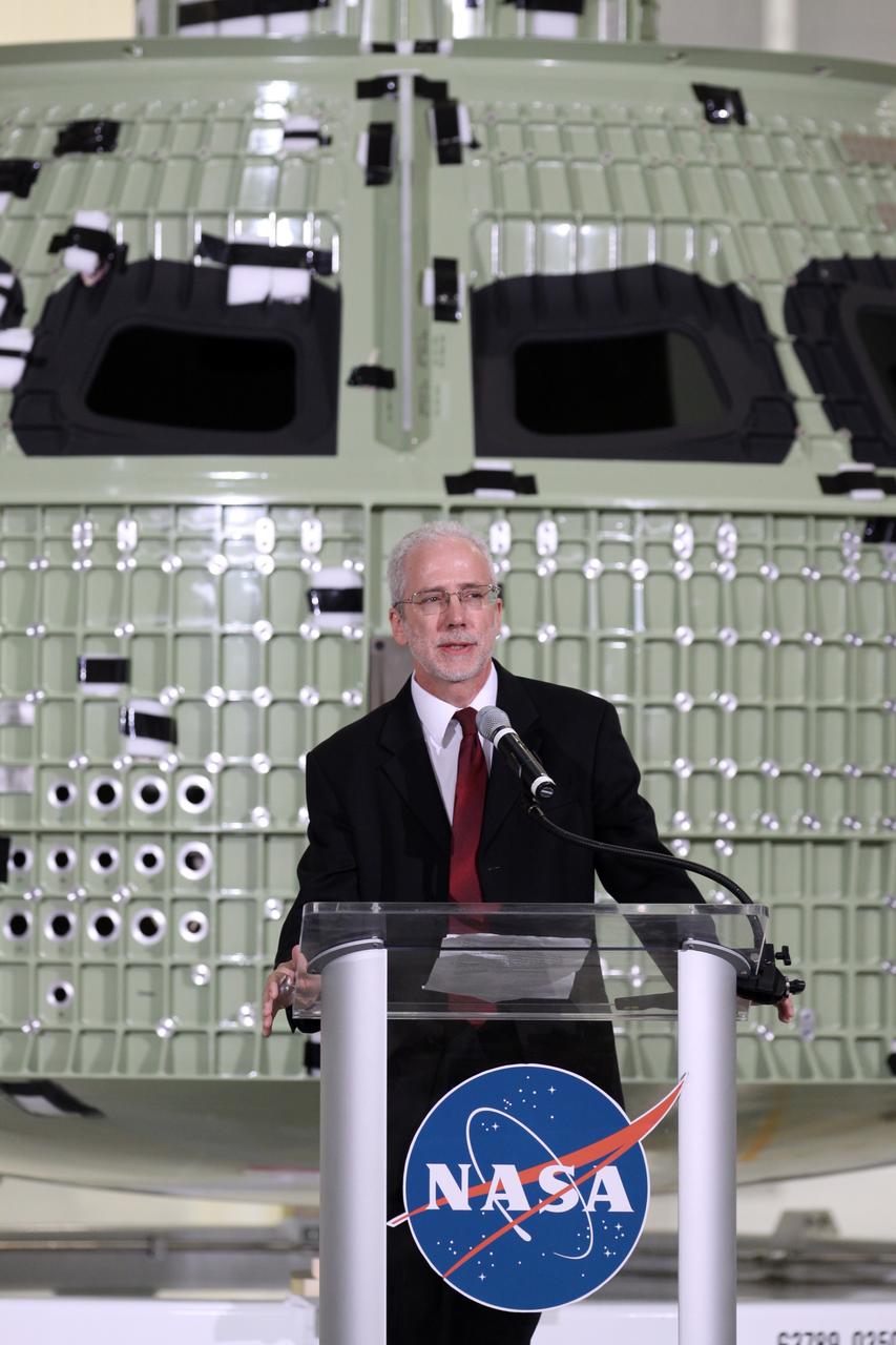 CAPE CANAVERAL, Fla. – Orion Program Manager Mark Geyer addresses the audience assembled in Kennedy Space Center's Operations and Checkout Building high bay for an event marking the arrival of NASA's first space-bound Orion capsule in Florida.    Slated for Exploration Flight Test-1, an uncrewed mission planned for 2014, the capsule will travel farther into space than any human spacecraft has gone in more than 40 years. The capsule was shipped to Kennedy from NASA's Michoud Assembly Facility in New Orleans where the crew module pressure vessel was built. The Orion production team will prepare the module for flight at Kennedy by installing heat-shielding thermal protection systems, avionics and other subsystems. For more information, visit http://www.nasa.gov/orion.  Photo credit: NASA/Kim Shiflett