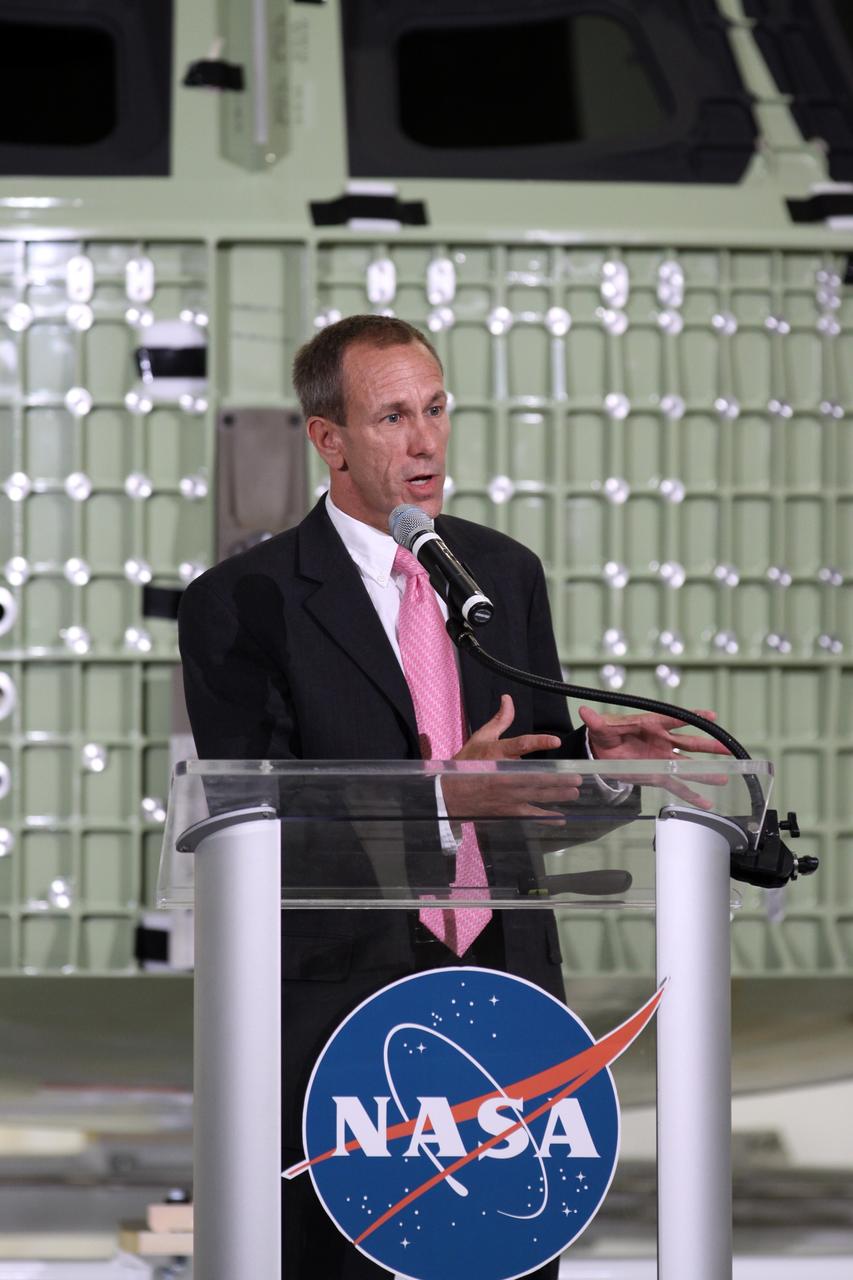 CAPE CANAVERAL, Fla. – David Beaman, NASA Space Launch System spacecraft and payload integration manager, addresses the audience assembled in Kennedy Space Center's Operations and Checkout Building high bay for an event marking the arrival of NASA's first space-bound Orion capsule in Florida.    Slated for Exploration Flight Test-1, an uncrewed mission planned for 2014, the capsule will travel farther into space than any human spacecraft has gone in more than 40 years. The capsule was shipped to Kennedy from NASA's Michoud Assembly Facility in New Orleans where the crew module pressure vessel was built. The Orion production team will prepare the module for flight at Kennedy by installing heat-shielding thermal protection systems, avionics and other subsystems. For more information, visit http://www.nasa.gov/orion.  Photo credit: NASA/Kim Shiflett