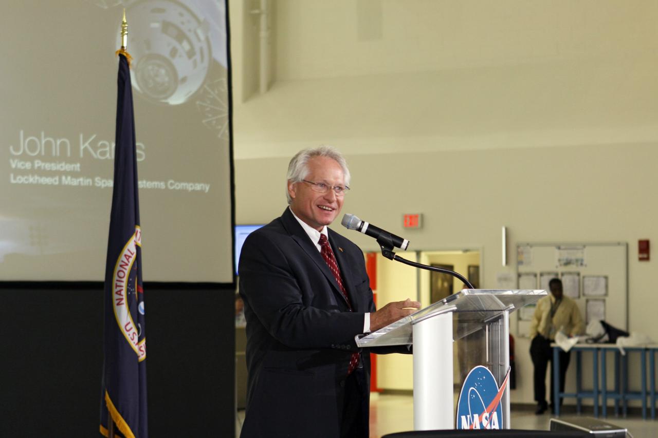 CAPE CANAVERAL, Fla. – John Karas, vice president and general manager of Human Spaceflight for Lockheed Martin Space Systems, addresses the audience assembled in Kennedy Space Center's Operations and Checkout Building high bay for an event marking the arrival of NASA's first space-bound Orion capsule in Florida.    Slated for Exploration Flight Test-1, an uncrewed mission planned for 2014, the capsule will travel farther into space than any human spacecraft has gone in more than 40 years. The capsule was shipped to Kennedy from NASA's Michoud Assembly Facility in New Orleans where the crew module pressure vessel was built. The Orion production team will prepare the module for flight at Kennedy by installing heat-shielding thermal protection systems, avionics and other subsystems. For more information, visit http://www.nasa.gov/orion.  Photo credit: NASA/Kim Shiflett