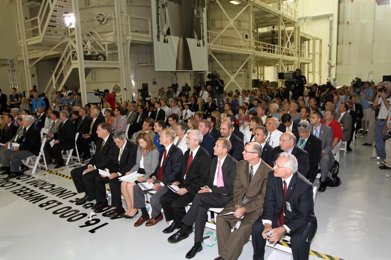 CAPE CANAVERAL, Fla. – Distinguished speakers are seated in the front row in Kennedy Space Center's Operations and Checkout Building high bay for an event marking the arrival of NASA's first space-bound Orion capsule in Florida.  From left are Dan Dumbacher, NASA deputy associate administrator for Exploration Systems Development, NASA Kennedy Space Center Director Robert Cabana, NASA Deputy Administrator Lori Garver, U.S. Senator Bill Nelson, Mark Geyer, Orion program manager, David Beaman, NASA Space Launch System spacecraft and payload integration manager, Pepper Phillips, program manager for NASA's Ground Systems Development and Operations, and John Karas, vice president and general manager of Human Spaceflight for Lockheed Martin Space Systems.      Slated for Exploration Flight Test-1, an uncrewed mission planned for 2014, the capsule will travel farther into space than any human spacecraft has gone in more than 40 years. The capsule was shipped to Kennedy from NASA's Michoud Assembly Facility in New Orleans where the crew module pressure vessel was built. The Orion production team will prepare the module for flight at Kennedy by installing heat-shielding thermal protection systems, avionics and other subsystems. For more information, visit http://www.nasa.gov/orion.  Photo credit: NASA/Kim Shiflett
