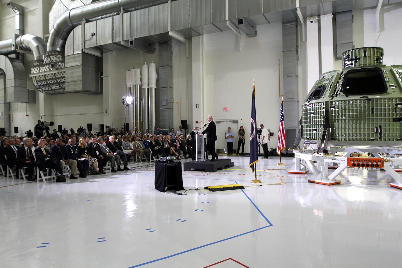 CAPE CANAVERAL, Fla. – Mark Geyer, Orion program manager, addresses the audience assembled in Kennedy Space Center's Operations and Checkout Building high bay for an event marking the arrival of NASA's first space-bound Orion capsule in Florida.    Slated for Exploration Flight Test-1, an uncrewed mission planned for 2014, the capsule will travel farther into space than any human spacecraft has gone in more than 40 years. The capsule was shipped to Kennedy from NASA's Michoud Assembly Facility in New Orleans where the crew module pressure vessel was built. The Orion production team will prepare the module for flight at Kennedy by installing heat-shielding thermal protection systems, avionics and other subsystems. For more information, visit http://www.nasa.gov/orion.  Photo credit: NASA/Kim Shiflett