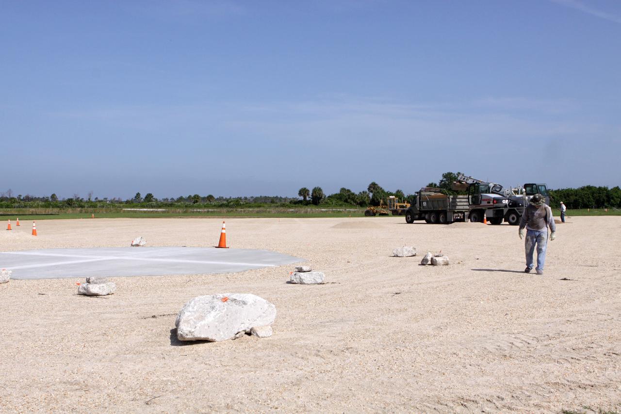 CAPE CANAVERAL, Fla. – Steady progress is made on the construction of the hazard field for the Project Morpheus lander near the Shuttle Landing Facility, or SLF, at NASA’s Kennedy Space Center in Florida. Testing of the prototype lander has been ongoing at NASA’s Johnson Space Center in Houston in preparation for its first free flight. The SLF will provide the lander with the kind of field necessary for realistic testing, complete with rocks, craters and hazards to avoid. Morpheus utilizes an autonomous landing and hazard avoidance technology, or ALHAT, payload that will allow it to navigate to clear landing sites amidst rocks, craters and other hazards during its descent. Project Morpheus is one of 20 small projects comprising the Advanced Exploration Systems, or AES, program in NASA’s Human Exploration and Operations Mission Directorate. AES projects pioneer new approaches for rapidly developing prototype systems, demonstrating key capabilities and validating operational concepts for future human missions beyond Earth orbit. For more information on Project Morpheus, visit http://www.nasa.gov/centers/johnson/exploration/morpheus/index.html. Photo credit: NASA/Kim Shiflett