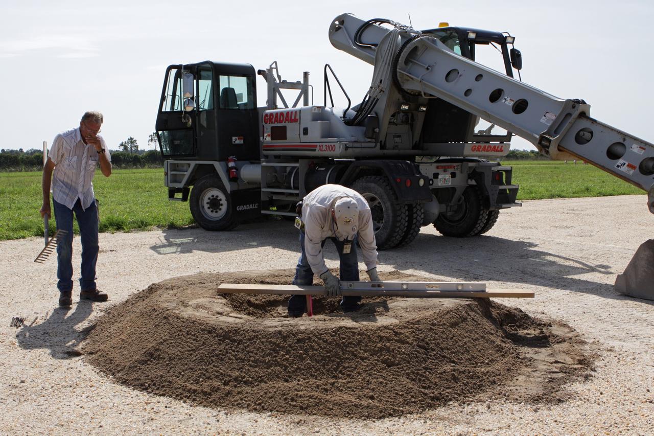 CAPE CANAVERAL, Fla. – Steady progress is made on the construction of the hazard field for the Project Morpheus lander near the Shuttle Landing Facility, or SLF, at NASA’s Kennedy Space Center in Florida. Testing of the prototype lander has been ongoing at NASA’s Johnson Space Center in Houston in preparation for its first free flight. The SLF will provide the lander with the kind of field necessary for realistic testing, complete with rocks, craters and hazards to avoid. Morpheus utilizes an autonomous landing and hazard avoidance technology, or ALHAT, payload that will allow it to navigate to clear landing sites amidst rocks, craters and other hazards during its descent. Project Morpheus is one of 20 small projects comprising the Advanced Exploration Systems, or AES, program in NASA’s Human Exploration and Operations Mission Directorate. AES projects pioneer new approaches for rapidly developing prototype systems, demonstrating key capabilities and validating operational concepts for future human missions beyond Earth orbit. For more information on Project Morpheus, visit http://www.nasa.gov/centers/johnson/exploration/morpheus/index.html. Photo credit: NASA/Kim Shiflett