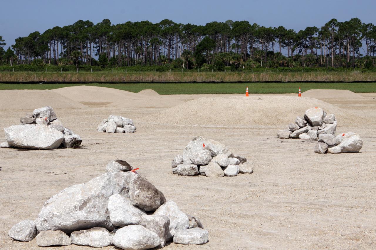 CAPE CANAVERAL, Fla. – Steady progress is made on the construction of the hazard field for the Project Morpheus lander near the Shuttle Landing Facility, or SLF, at NASA’s Kennedy Space Center in Florida. Testing of the prototype lander has been ongoing at NASA’s Johnson Space Center in Houston in preparation for its first free flight. The SLF will provide the lander with the kind of field necessary for realistic testing, complete with rocks, craters and hazards to avoid. Morpheus utilizes an autonomous landing and hazard avoidance technology, or ALHAT, payload that will allow it to navigate to clear landing sites amidst rocks, craters and other hazards during its descent. Project Morpheus is one of 20 small projects comprising the Advanced Exploration Systems, or AES, program in NASA’s Human Exploration and Operations Mission Directorate. AES projects pioneer new approaches for rapidly developing prototype systems, demonstrating key capabilities and validating operational concepts for future human missions beyond Earth orbit. For more information on Project Morpheus, visit http://www.nasa.gov/centers/johnson/exploration/morpheus/index.html. Photo credit: NASA/Kim Shiflett
