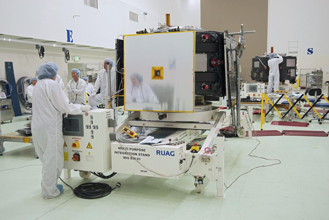 CAPE CANAVERAL, Fla. - Inside the Astrotech payload processing facility near NASA’s Kennedy Space Center in Florida, technicians prepare to deploy the magnetometer boom of the Radiation Belt Storm Probes, or RBSP, spacecraft A. Deploying this instrument is standard procedure to ensure it will work properly on Earth before it heads into space. In the back right of the facility, is spacecraft B, which is identical to spacecraft A. Together, NASA’s two RBSP spacecraft will help us understand the sun’s influence on Earth and near-Earth space by studying the Earth’s radiation belts on various scales of space and time. The boom will provide data of the electric fields that energize radiation particles and modify the structure of the inner magnetosphere. RBSP will begin its mission of exploration of Earth’s Van Allen radiation belts and the extremes of space weather after its launch aboard a United Launch Alliance Atlas V rocket. Launch is targeted for Aug. 23. For more information, visit http://www.nasa.gov/rbsp. Photo credit: NASA/Charisse Nahser