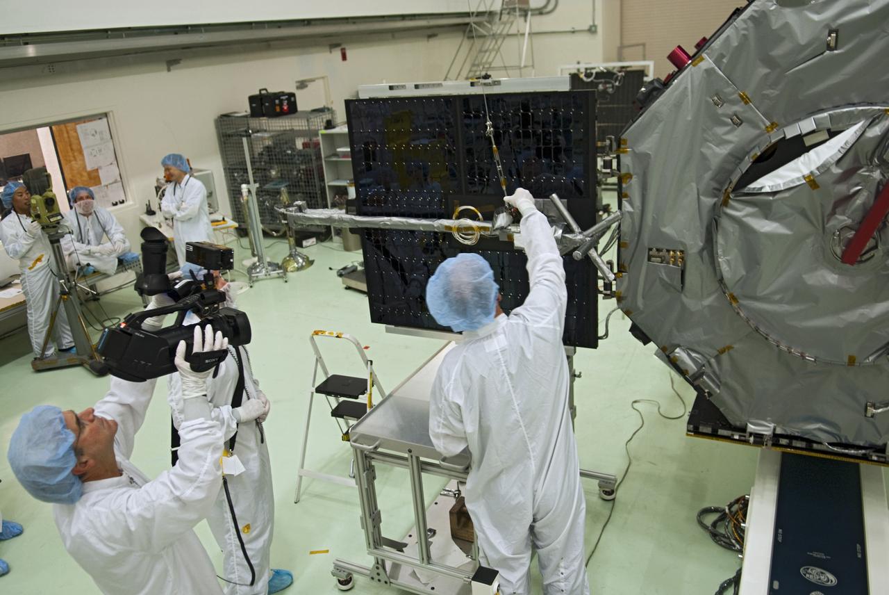 CAPE CANAVERAL, Fla. - Inside the Astrotech payload processing facility near NASA’s Kennedy Space Center in Florida, technicians deploy one of four solar panels on the Radiation Belt Storm Probes, or RBSP, spacecraft A. Deploying these arrays is standard procedure to ensure they work properly on Earth before they head into space. NASA’s RBSP mission will help us understand the sun’s influence on Earth and near-Earth space by studying the Earth’s radiation belts on various scales of space and time. As the spacecraft orbits Earth, the panels will continuously face the sun to provide constant power to its instruments. RBSP will begin its mission of exploration of Earth’s Van Allen radiation belts and the extremes of space weather after its launch aboard a United Launch Alliance Atlas V rocket. Launch is targeted for Aug. 23. For more information, visit http://www.nasa.gov/rbsp. Photo credit: NASA/Charisse Nahser