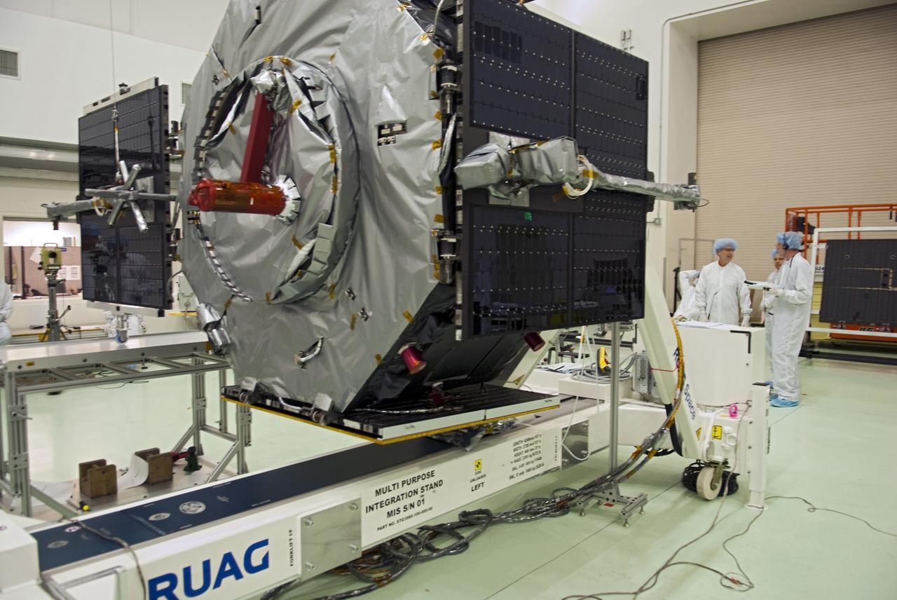 CAPE CANAVERAL, Fla. - Inside the Astrotech payload processing facility near NASA’s Kennedy Space Center in Florida, technicians deploy one of four solar panels on the Radiation Belt Storm Probes, or RBSP, spacecraft A. Deploying these arrays is standard procedure to ensure they work properly on Earth before they head into space. NASA’s RBSP mission will help us understand the sun’s influence on Earth and near-Earth space by studying the Earth’s radiation belts on various scales of space and time. As the spacecraft orbits Earth, the panels will continuously face the sun to provide constant power to its instruments. RBSP will begin its mission of exploration of Earth’s Van Allen radiation belts and the extremes of space weather after its launch aboard a United Launch Alliance Atlas V rocket. Launch is targeted for Aug. 23. For more information, visit http://www.nasa.gov/rbsp. Photo credit: NASA/Charisse Nahser