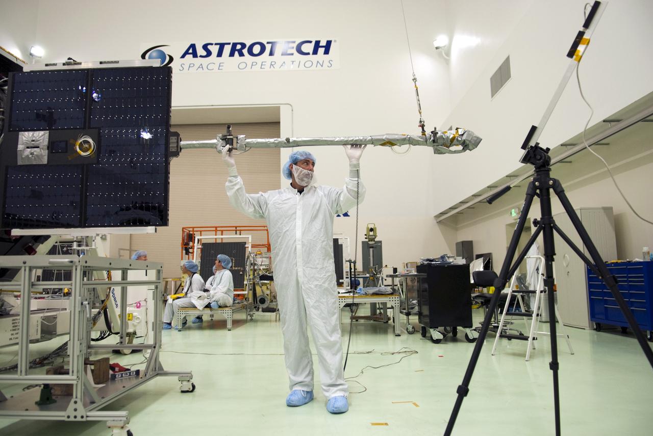 CAPE CANAVERAL, Fla. - Inside the Astrotech payload processing facility near NASA’s Kennedy Space Center in Florida, a technician inspects the Radiation Belt Storm Probes, or RBSP, spacecraft A solar arrays and magnetometer boom after they were deployed. Deploying these components is a standard procedure to ensure they work properly on Earth before they head into space. NASA’s RBSP mission will help us understand the sun’s influence on Earth and near-Earth space by studying the Earth’s radiation belts on various scales of space and time. As the spacecraft orbits Earth, the four solar panels will continuously face the sun to provide constant power to its instruments. The boom will provide data of the electric fields that energize radiation particles and modify the structure of the inner magnetosphere. RBSP will begin its mission of exploration of Earth’s Van Allen radiation belts and the extremes of space weather after its launch aboard a United Launch Alliance Atlas V rocket. Launch is targeted for Aug. 23. For more information, visit http://www.nasa.gov/rbsp. Photo credit: NASA/Charisse Nahser