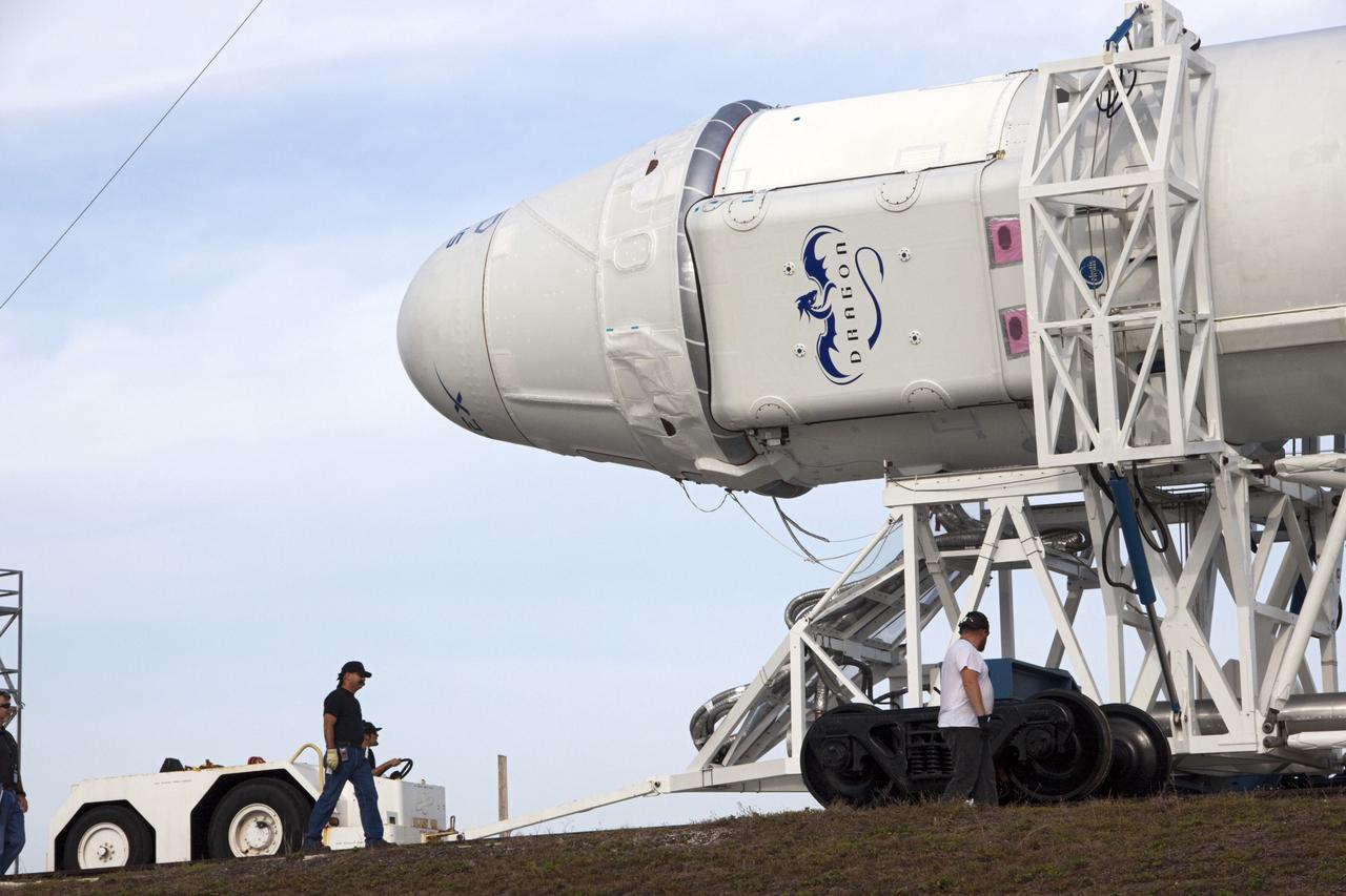 CAPE CANAVERAL, Fla. – As technicians monitor the progress of the transporter, the SpaceX Falcon 9 rocket with its Dragon spacecraft arrive at Space Launch Complex-40 on Cape Canaveral Air Force Station in Florida. Liftoff with the SpaceX Falcon 9 is set for 4:55 a.m. EDT on May 19. The launch will be the company's second demonstration test flight for NASA's Commercial Orbital Transportation Services Program, or COTS.    During the flight, the capsule will conduct a series of check-out procedures to test and prove its systems, including rendezvous and berthing with the International Space Station. If the capsule performs as planned, the cargo and experiments it is carrying will be transferred to the station. The cargo includes food, water and provisions for the station’s Expedition crews, such as clothing, batteries and computer equipment. Under COTS, NASA has partnered with two aerospace companies to deliver cargo to the station. For more information, visit http://www.nasa.gov/spacex Photo credit: NASA/Jim Grossmann