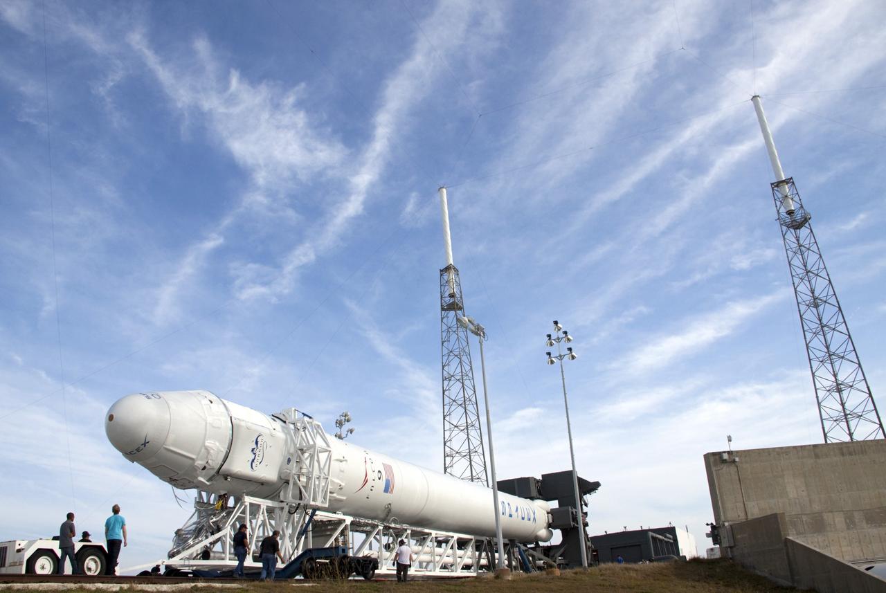 CAPE CANAVERAL, Fla. – Under the watchful eye of technicians, the SpaceX Falcon 9 rocket arrives at Space Launch Complex-40 on Cape Canaveral Air Force Station in Florida. Liftoff with the SpaceX Dragon capsule aboard is set for 4:55 a.m. EDT on May 19. The launch will be the company's second demonstration test flight for NASA's Commercial Orbital Transportation Services Program, or COTS.    During the flight, the capsule will conduct a series of check-out procedures to test and prove its systems, including rendezvous and berthing with the International Space Station. If the capsule performs as planned, the cargo and experiments it is carrying will be transferred to the station. The cargo includes food, water and provisions for the station’s Expedition crews, such as clothing, batteries and computer equipment. Under COTS, NASA has partnered with two aerospace companies to deliver cargo to the station. For more information, visit http://www.nasa.gov/spacex Photo credit: NASA/Jim Grossmann