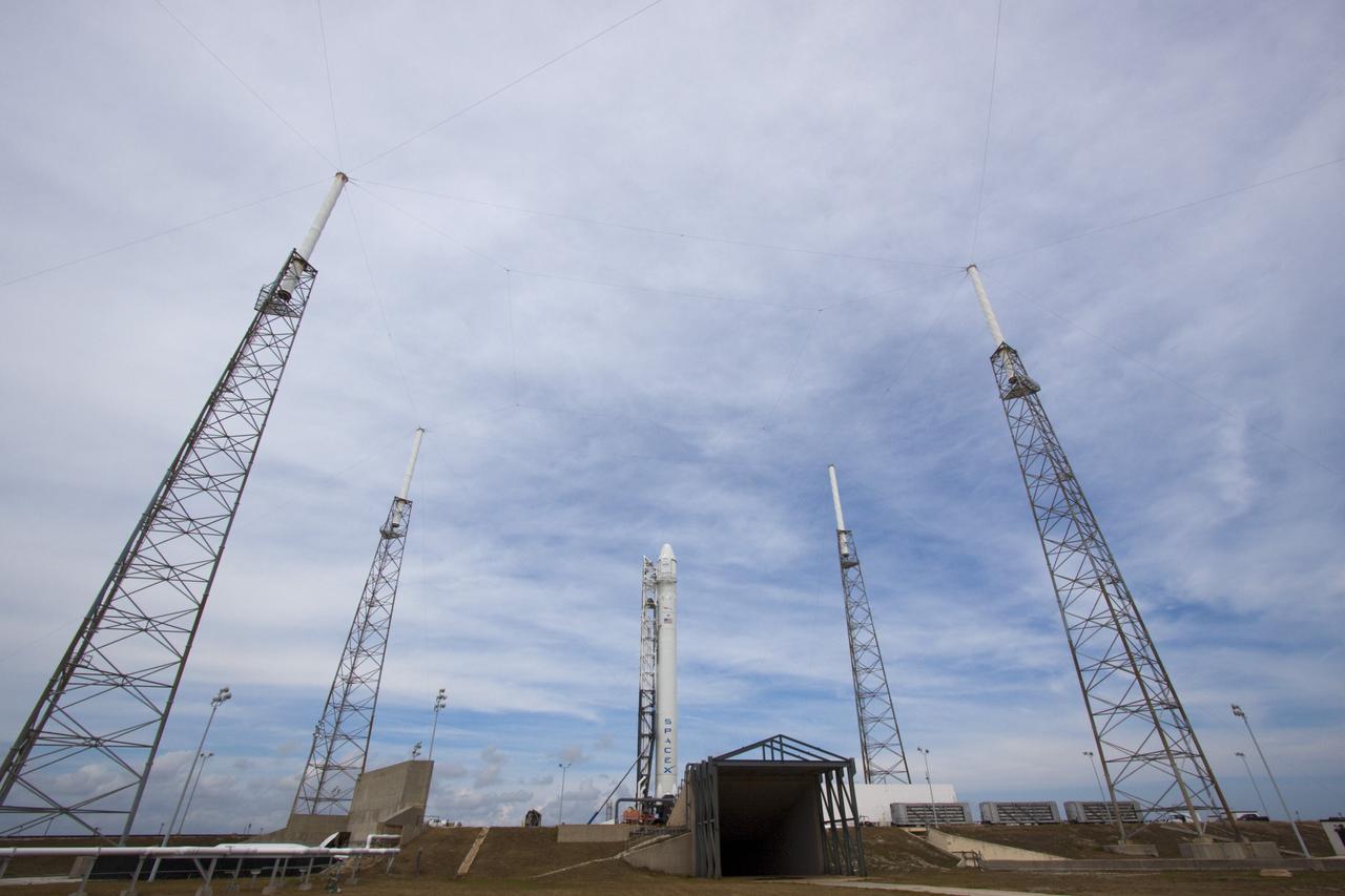 CAPE CANAVERAL, Fla. – Surrounded by four lightning suppression system towers, the SpaceX Falcon 9 rocket stands at Space Launch Complex-40 on Cape Canaveral Air Force Station in Florida. Liftoff with the SpaceX Dragon capsule aboard is set for 4:55 a.m. EDT on May 19. The launch will be the company's second demonstration test flight for NASA's Commercial Orbital Transportation Services Program, or COTS.    During the flight, the capsule will conduct a series of check-out procedures to test and prove its systems, including rendezvous and berthing with the International Space Station. If the capsule performs as planned, the cargo and experiments it is carrying will be transferred to the station. The cargo includes food, water and provisions for the station’s Expedition crews, such as clothing, batteries and computer equipment. Under COTS, NASA has partnered with two aerospace companies to deliver cargo to the station. For more information, visit http://www.nasa.gov/spacex Photo credit: NASA/Jim Grossmann