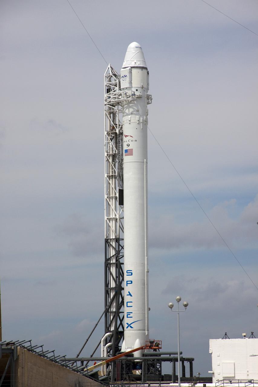 CAPE CANAVERAL, Fla. – The 227-foot-tall 69.2 meter) SpaceX Falcon 9 rocket stands at Space Launch Complex-40 on Cape Canaveral Air Force Station in Florida. Liftoff with the SpaceX Dragon capsule aboard is set for 4:55 a.m. EDT on May 19. The launch will be the company's second demonstration test flight for NASA's Commercial Orbital Transportation Services Program, or COTS.      During the flight, the capsule will conduct a series of check-out procedures to test and prove its systems, including rendezvous and berthing with the International Space Station. If the capsule performs as planned, the cargo and experiments it is carrying will be transferred to the station. The cargo includes food, water and provisions for the station’s Expedition crews, such as clothing, batteries and computer equipment. Under COTS, NASA has partnered with two aerospace companies to deliver cargo to the station. For more information, visit http://www.nasa.gov/spacex Photo credit: NASA/Jim Grossmann