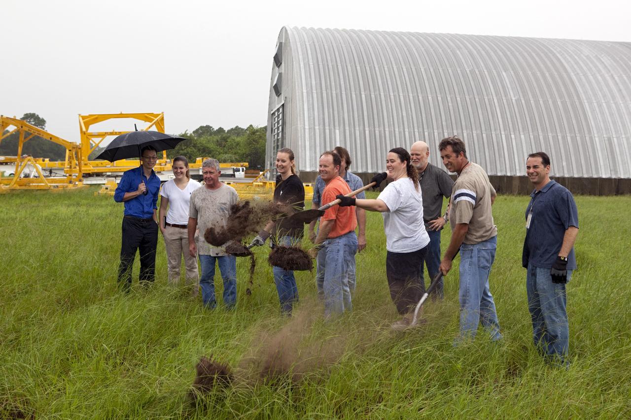 CAPE CANAVERAL, Fla. – Near the Hypergolic Maintenance Facility at NASA’s Kennedy Space Center in Florida, a groundbreaking ceremony was held to mark the location of the Ground Operations Demonstration Unit Liquid Hydrogen, or GODU LH2, test site. From left, are Johnny Nguyen, Fluids Test and Technology Development branch chief Emily Watkins, engineering intern Jeff Walls, Engineering Services Contract, or ESC, Cryogenics Test Lab engineer Kelly Currin, systems engineer Stephen Huff and Rudy Werlink partially hidden, cryogenics engineers Angela Krenn, systems engineer Doug Hammond, command and control engineer in the electrical division William Notardonato, GODU LH2 project manager and Kevin Jumper, ESC Cryogenics Test Lab manager.    The GODU LH2 test site is one of the projects in NASA’s Advanced Exploration Systems Program. The site will be used to demonstrate advanced liquid hydrogen systems that are cost and energy efficient ways to store and transfer liquid hydrogen during process, loading, launch and spaceflight. The main components of the site will be a storage tank and a cryogenic refrigerator.  Photo credit: NASA/Dimitri Gerondidakis