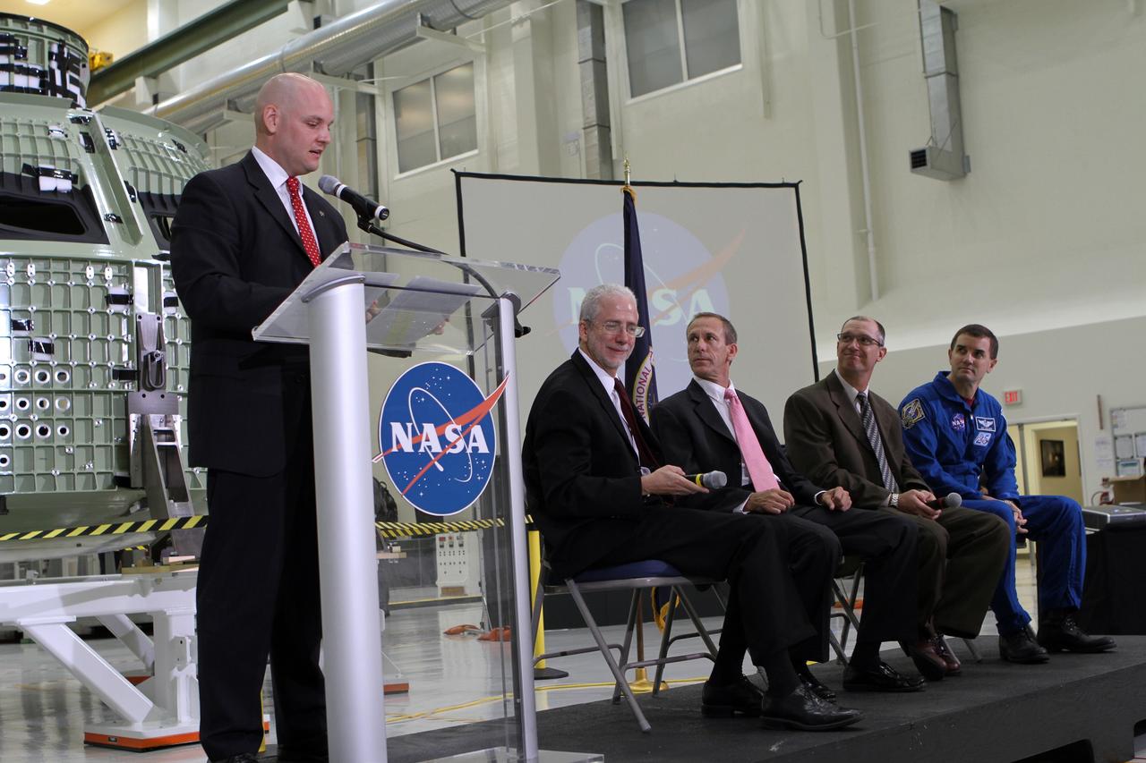 CAPE CANAVERAL, Fla. – Trent Perrotto of NASA Public Affairs addresses an audience of participants during a NASA social question and answer session. The group is assembled in Kennedy Space Center's Operations and Checkout Building high bay for an event marking the arrival of NASA's first space-bound Orion capsule in Florida. Joining Perrotto on stage, from the left, are Mark Geyer, Orion program manager David Beaman, NASA Space Launch System spacecraft and payload integration manager Pepper Phillips, program manager for NASA's Ground Systems Development and Operations and NASA astronaut Rex Walheim.      The tweeters will share their experiences with followers through the social networking site Twitter. Slated for Exploration Flight Test-1, an uncrewed mission planned for 2014, the capsule will travel farther into space than any human spacecraft has gone in more than 40 years. NASA's Michoud Assembly Facility in New Orleans built the crew module pressure vessel. The Orion production team will prepare the module for flight by installing heat-shielding thermal protection systems, avionics and other subsystems. For more information, visit http://www.nasa.gov/orion Photo credit: NASA/Kim Shiflett