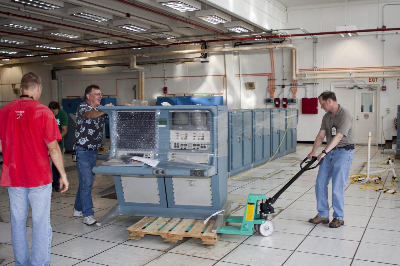 CAPE CANAVERAL, Fla. - In Firing Room 3 of the Launch Control Center at NASA’s Kennedy Space Center in Florida, technicians are removing legacy consoles and monitors to make way for new systems designed to be flexible so controllers can process and launch multiple types of rockets and spacecraft, whether they are government or commercial models.      KSC’s Launch Complex 39 is transitioning to support multiple users with the Firing Rooms being modified to be more generic in nature for upcoming programs. Photo credit: NASA/Jim Grossmann