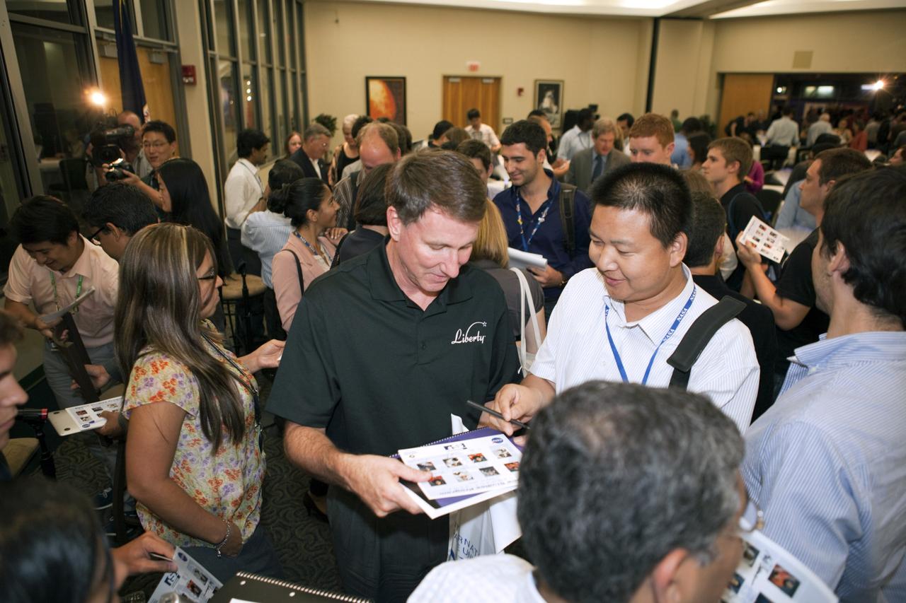 CAPE CANAVERAL, Fla. – Kent Rominger, vice president with Alliant Techsystems and former NASA astronaut, signs autographs and talks with participants of the International Space University during a panel discussion on the future of human spaceflight at the Kennedy Space Center Visitor Complex in Florida.     The International Space University is a nine-week intensive course designed for post-graduate university students and professionals during the summer. The program is hosted by a different country each year, providing a unique educational experience for participants from around the world. NASA Kennedy Space Center and the Florida Institute of Technology in Melbourne, Fla., are co-hosting this year’s event which runs from June 4 to Aug. 3. There are about 125 participants representing 31 countries. For more information, visit http://www.isunet.edu. Photo credit: NASA/Kim Shiflett