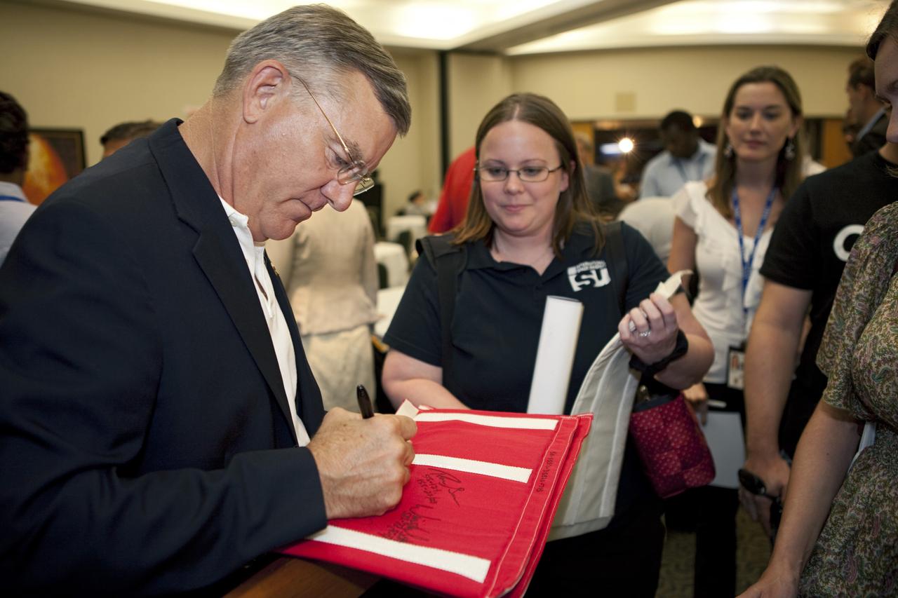 CAPE CANAVERAL, Fla. – Jim Voss, director of advanced programs at Sierra Nevada Corporation and former NASA astronaut, signs autographs and talks with participants of the International Space University during a panel discussion on the future of human spaceflight at the Kennedy Space Center Visitor Complex in Florida.     The International Space University is a nine-week intensive course designed for post-graduate university students and professionals during the summer. The program is hosted by a different country each year, providing a unique educational experience for participants from around the world. NASA Kennedy Space Center and the Florida Institute of Technology in Melbourne, Fla., are co-hosting this year’s event which runs from June 4 to Aug. 3. There are about 125 participants representing 31 countries. For more information, visit http://www.isunet.edu. Photo credit: NASA/Kim Shiflett