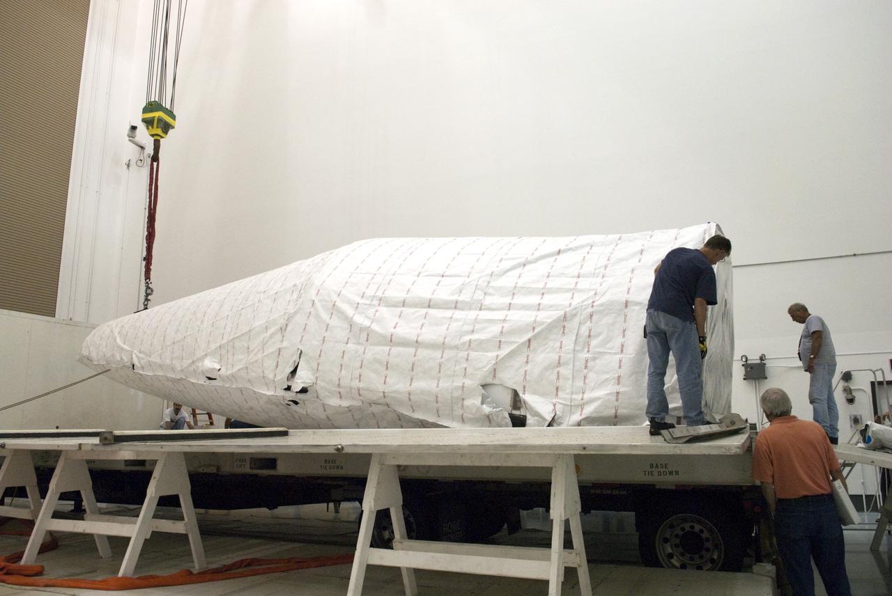CAPE CANAVERAL, Fla. - Inside the Astrotech payload processing facility near NASA’s Kennedy Space Center in Florida, technicians uncrate and prepare to uncover the nose cone fairing for the Radiation Belt Storm Probes, or RBSP, spacecraft. The nose faring will house and protect the RBSP during liftoff aboard an Atlas V rocket. NASA’s RBSP mission will help us understand the sun’s influence on Earth and near-Earth space by studying the Earth’s radiation belts on various scales of space and time. RBSP will begin its mission of exploration of Earth’s Van Allen radiation belts and the extremes of space weather after its liftoff aboard a United Launch Alliance Atlas V from Space Launch Complex 41 at Cape Canaveral Air Force Station, Fla. Liftoff is targeted for Aug. 23, 2012. For more information, visit http://www.nasa.gov/rbsp. Photo credit: NASA/Charisse Nahser