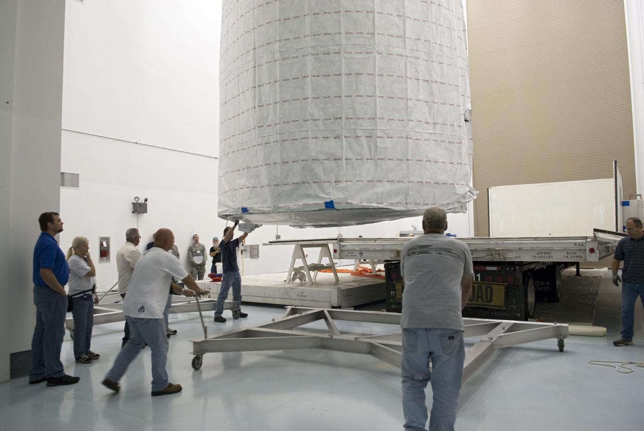 CAPE CANAVERAL, Fla. - Inside the Astrotech payload processing facility near NASA’s Kennedy Space Center in Florida, technicians offload and prepare to uncover the nose cone fairing for the Radiation Belt Storm Probes, or RBSP, spacecraft. The nose faring will house and protect the RBSP during liftoff aboard an Atlas V rocket. NASA’s RBSP mission will help us understand the sun’s influence on Earth and near-Earth space by studying the Earth’s radiation belts on various scales of space and time. RBSP will begin its mission of exploration of Earth’s Van Allen radiation belts and the extremes of space weather after its liftoff aboard a United Launch Alliance Atlas V from Space Launch Complex 41 at Cape Canaveral Air Force Station, Fla. Liftoff is targeted for Aug. 23, 2012. For more information, visit http://www.nasa.gov/rbsp. Photo credit: NASA/Charisse Nahser