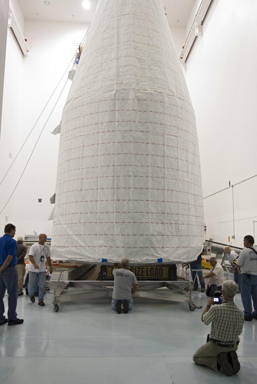 CAPE CANAVERAL, Fla. - Inside the Astrotech payload processing facility near NASA’s Kennedy Space Center in Florida, technicians offload, inspect and prepare to uncover the nose cone fairing for the Radiation Belt Storm Probes, or RBSP, spacecraft. The nose faring will house and protect the RBSP during liftoff aboard an Atlas V rocket. NASA’s RBSP mission will help us understand the sun’s influence on Earth and near-Earth space by studying the Earth’s radiation belts on various scales of space and time. RBSP will begin its mission of exploration of Earth’s Van Allen radiation belts and the extremes of space weather after its liftoff aboard a United Launch Alliance Atlas V from Space Launch Complex 41 at Cape Canaveral Air Force Station, Fla. Liftoff is targeted for Aug. 23, 2012. For more information, visit http://www.nasa.gov/rbsp. Photo credit: NASA/Charisse Nahser