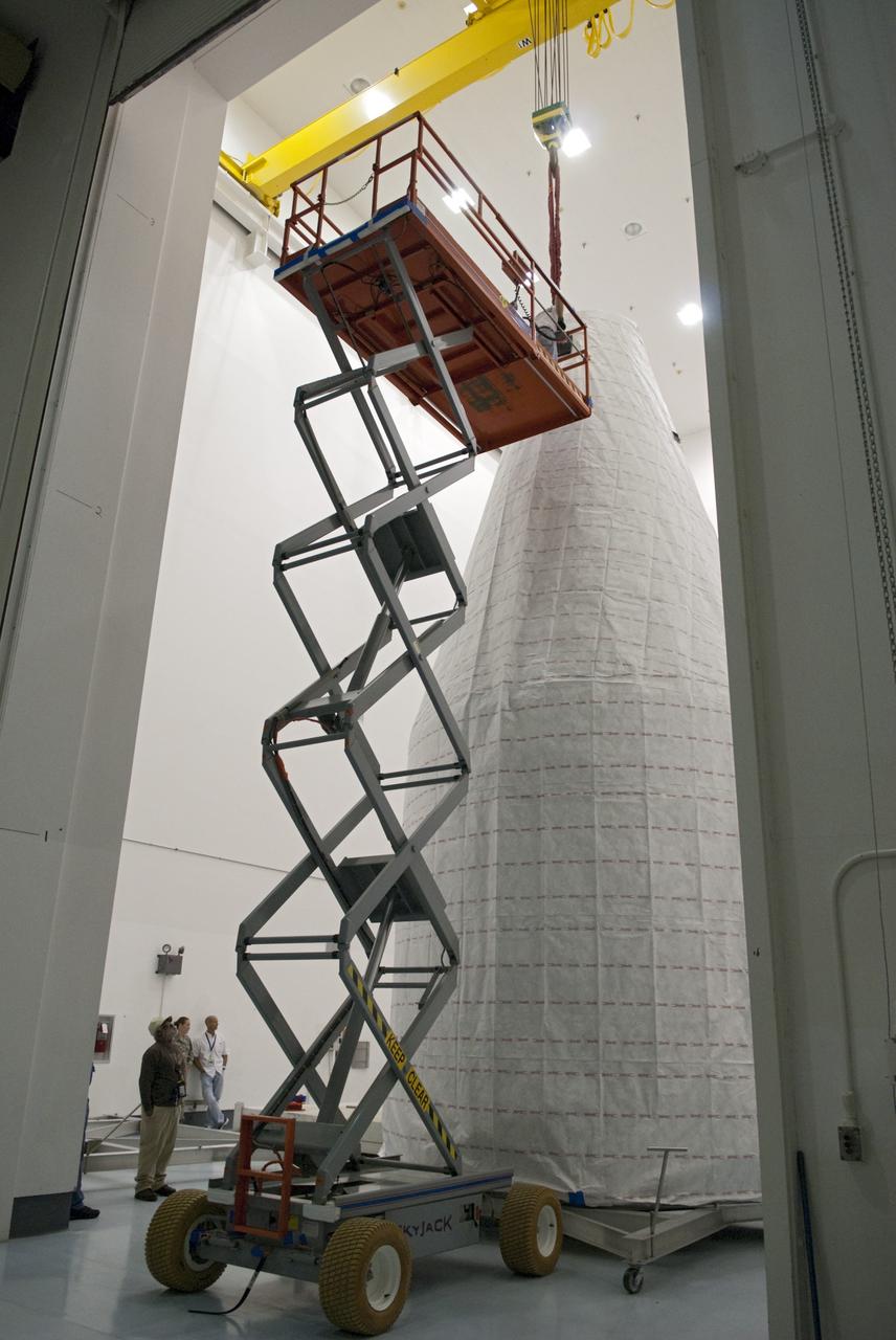 CAPE CANAVERAL, Fla. - Inside the Astrotech payload processing facility near NASA’s Kennedy Space Center in Florida, technicians use a lift to inspect the nose cone fairing for the Radiation Belt Storm Probes, or RBSP, spacecraft. The nose faring will house and protect the RBSP during liftoff aboard an Atlas V rocket. NASA’s RBSP mission will help us understand the sun’s influence on Earth and near-Earth space by studying the Earth’s radiation belts on various scales of space and time. RBSP will begin its mission of exploration of Earth’s Van Allen radiation belts and the extremes of space weather after its liftoff aboard a United Launch Alliance Atlas V from Space Launch Complex 41 at Cape Canaveral Air Force Station, Fla. Liftoff is targeted for Aug. 23, 2012. For more information, visit http://www.nasa.gov/rbsp. Photo credit: NASA/Charisse Nahser