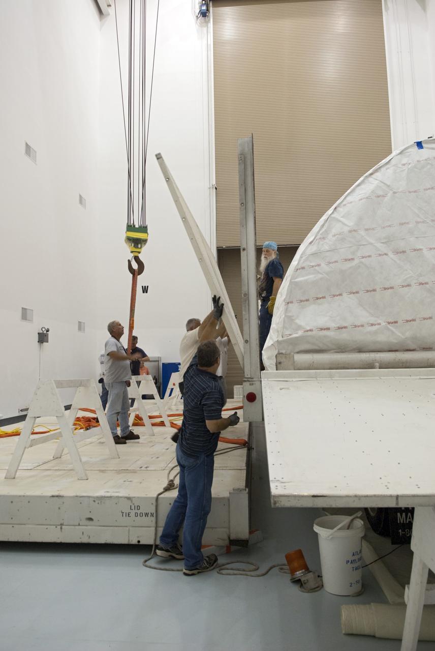 CAPE CANAVERAL, Fla. - Inside the Astrotech payload processing facility near NASA’s Kennedy Space Center in Florida, technicians uncrate and prepare to uncover the nose cone fairing for the Radiation Belt Storm Probes, or RBSP, spacecraft. The nose faring will house and protect the RBSP during liftoff aboard an Atlas V rocket. NASA’s RBSP mission will help us understand the sun’s influence on Earth and near-Earth space by studying the Earth’s radiation belts on various scales of space and time. RBSP will begin its mission of exploration of Earth’s Van Allen radiation belts and the extremes of space weather after its liftoff aboard a United Launch Alliance Atlas V from Space Launch Complex 41 at Cape Canaveral Air Force Station, Fla. Liftoff is targeted for Aug. 23, 2012. For more information, visit http://www.nasa.gov/rbsp. Photo credit: NASA/Charisse Nahser