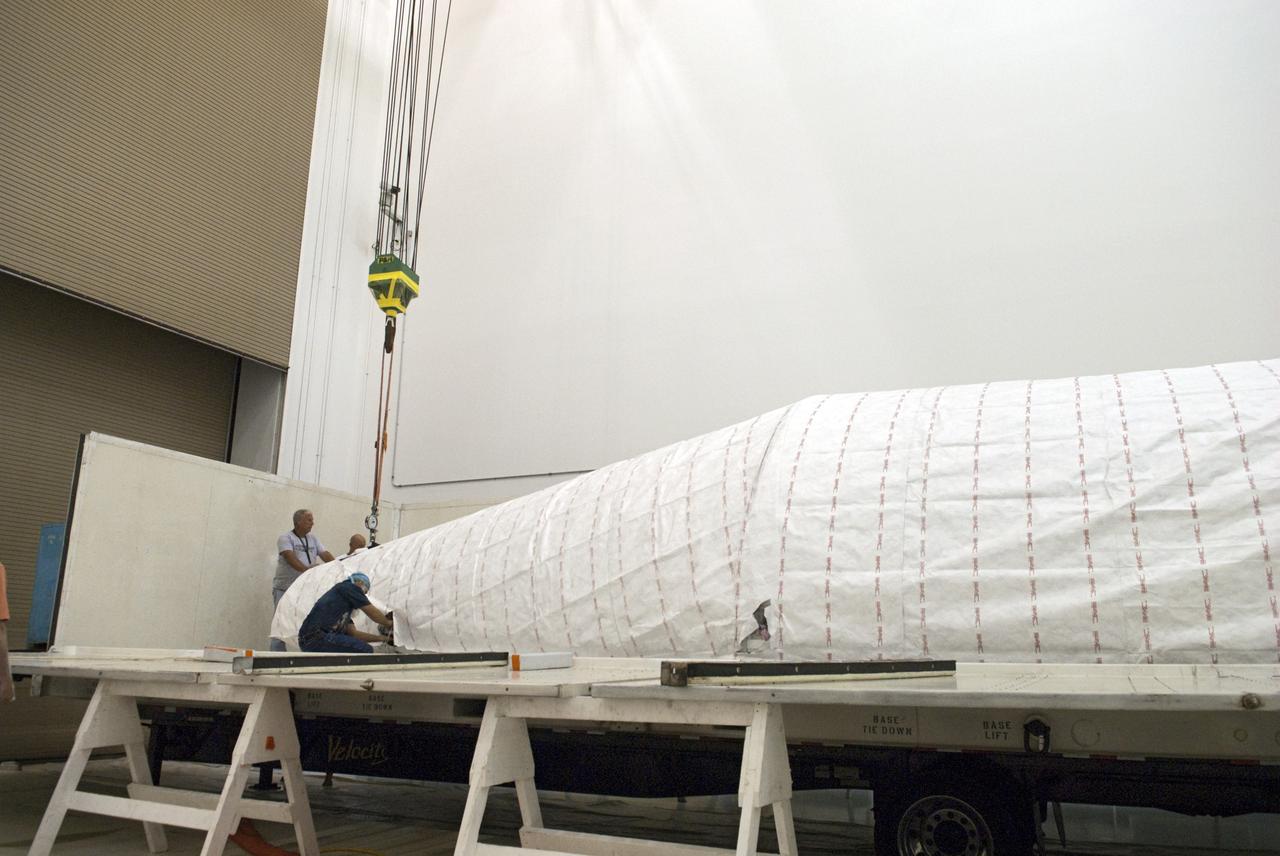 CAPE CANAVERAL, Fla. - Inside the Astrotech payload processing facility near NASA’s Kennedy Space Center in Florida, technicians uncrate and prepare to uncover the nose cone fairing for the Radiation Belt Storm Probes, or RBSP, spacecraft. The nose faring will house and protect the RBSP during liftoff aboard an Atlas V rocket. NASA’s RBSP mission will help us understand the sun’s influence on Earth and near-Earth space by studying the Earth’s radiation belts on various scales of space and time. RBSP will begin its mission of exploration of Earth’s Van Allen radiation belts and the extremes of space weather after its liftoff aboard a United Launch Alliance Atlas V from Space Launch Complex 41 at Cape Canaveral Air Force Station, Fla. Liftoff is targeted for Aug. 23, 2012. For more information, visit http://www.nasa.gov/rbsp. Photo credit: NASA/Charisse Nahser