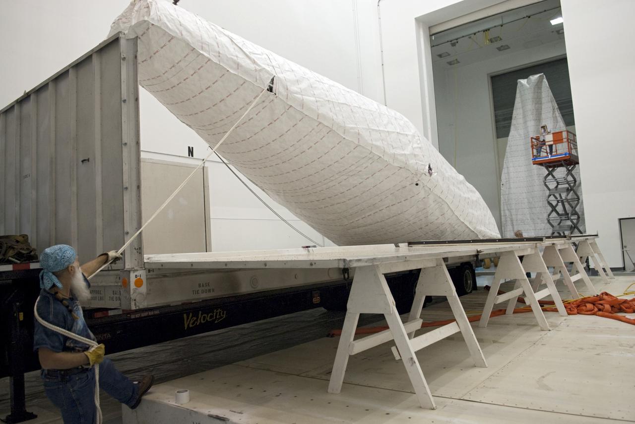 CAPE CANAVERAL, Fla. - Inside the Astrotech payload processing facility near NASA’s Kennedy Space Center in Florida, technicians offload and prepare to uncover the nose cone fairing for the Radiation Belt Storm Probes, or RBSP, spacecraft. The nose faring will house and protect the RBSP during liftoff aboard an Atlas V rocket. NASA’s RBSP mission will help us understand the sun’s influence on Earth and near-Earth space by studying the Earth’s radiation belts on various scales of space and time. RBSP will begin its mission of exploration of Earth’s Van Allen radiation belts and the extremes of space weather after its liftoff aboard a United Launch Alliance Atlas V from Space Launch Complex 41 at Cape Canaveral Air Force Station, Fla. Liftoff is targeted for Aug. 23, 2012. For more information, visit http://www.nasa.gov/rbsp. Photo credit: NASA/Charisse Nahser