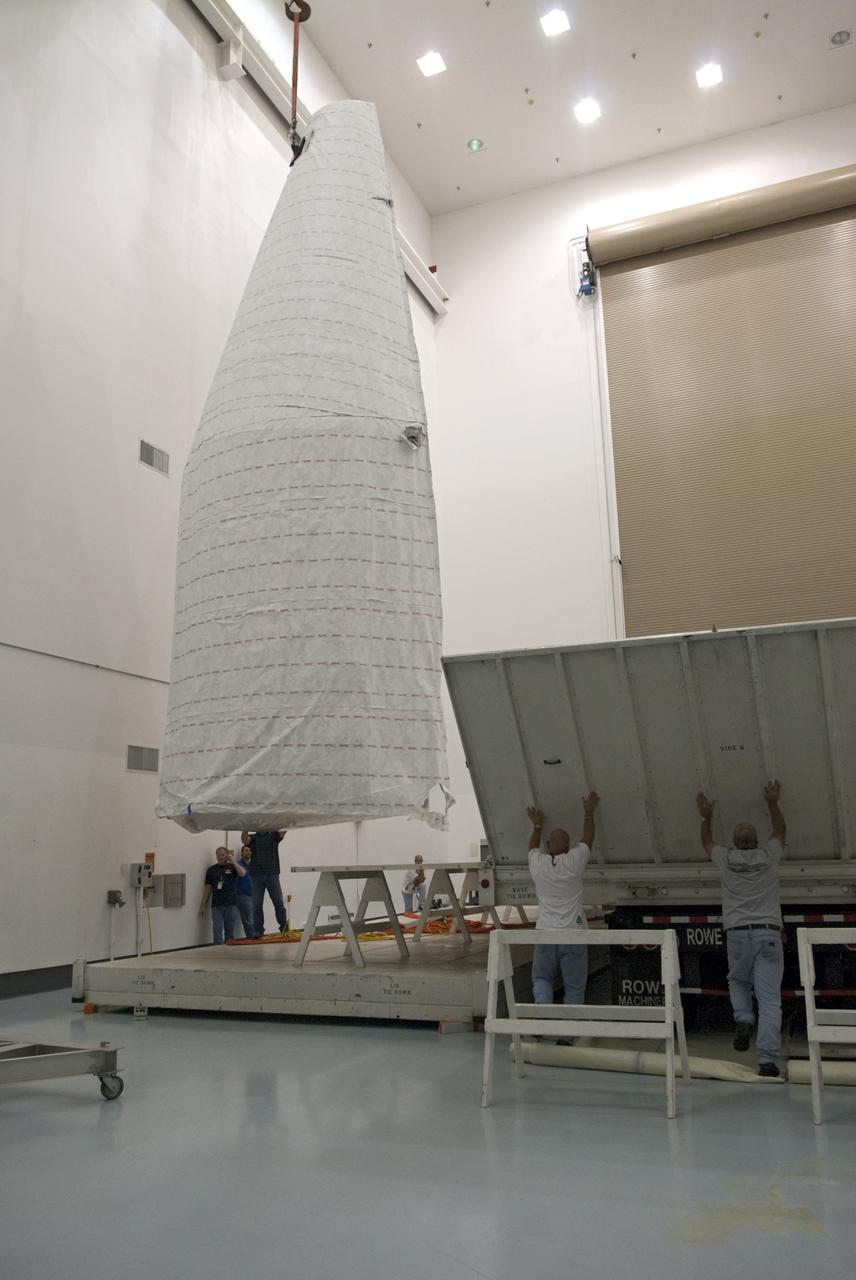CAPE CANAVERAL, Fla. - Inside the Astrotech payload processing facility near NASA’s Kennedy Space Center in Florida, technicians uncrate, offload and prepare to uncover the nose cone fairing for the Radiation Belt Storm Probes, or RBSP, spacecraft. The nose faring will house and protect the RBSP during liftoff aboard an Atlas V rocket. NASA’s RBSP mission will help us understand the sun’s influence on Earth and near-Earth space by studying the Earth’s radiation belts on various scales of space and time. RBSP will begin its mission of exploration of Earth’s Van Allen radiation belts and the extremes of space weather after its liftoff aboard a United Launch Alliance Atlas V from Space Launch Complex 41 at Cape Canaveral Air Force Station, Fla. Liftoff is targeted for Aug. 23, 2012. For more information, visit http://www.nasa.gov/rbsp. Photo credit: NASA/Charisse Nahser