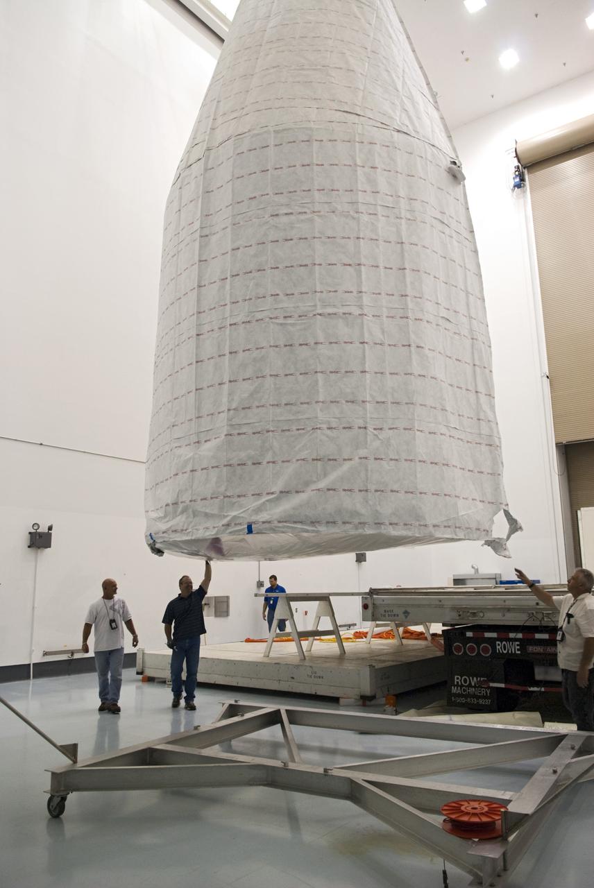 CAPE CANAVERAL, Fla. - Inside the Astrotech payload processing facility near NASA’s Kennedy Space Center in Florida, technicians offload, inspect and prepare to uncover the nose cone fairing for the Radiation Belt Storm Probes, or RBSP, spacecraft. The nose faring will house and protect the RBSP during liftoff aboard an Atlas V rocket. NASA’s RBSP mission will help us understand the sun’s influence on Earth and near-Earth space by studying the Earth’s radiation belts on various scales of space and time. RBSP will begin its mission of exploration of Earth’s Van Allen radiation belts and the extremes of space weather after its liftoff aboard a United Launch Alliance Atlas V from Space Launch Complex 41 at Cape Canaveral Air Force Station, Fla. Liftoff is targeted for Aug. 23, 2012. For more information, visit http://www.nasa.gov/rbsp. Photo credit: NASA/Charisse Nahser