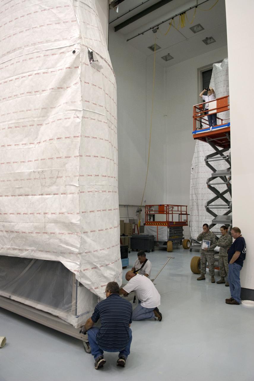 CAPE CANAVERAL, Fla. - Inside the Astrotech payload processing facility near NASA’s Kennedy Space Center in Florida, technicians uncrate, inspect and prepare to uncover the nose cone fairing for the Radiation Belt Storm Probes, or RBSP, spacecraft. The nose faring will house and protect the RBSP during liftoff aboard an Atlas V rocket. NASA’s RBSP mission will help us understand the sun’s influence on Earth and near-Earth space by studying the Earth’s radiation belts on various scales of space and time. RBSP will begin its mission of exploration of Earth’s Van Allen radiation belts and the extremes of space weather after its liftoff aboard a United Launch Alliance Atlas V from Space Launch Complex 41 at Cape Canaveral Air Force Station, Fla. Liftoff is targeted for Aug. 23, 2012. For more information, visit http://www.nasa.gov/rbsp. Photo credit: NASA/Charisse Nahser