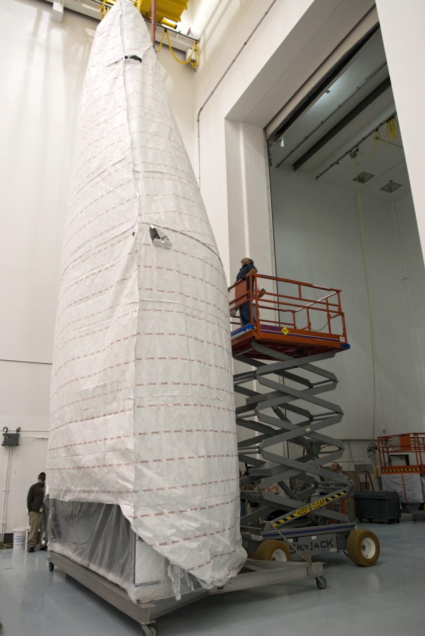 CAPE CANAVERAL, Fla. - Inside the Astrotech payload processing facility near NASA’s Kennedy Space Center in Florida, technicians use a lift to inspect the nose cone fairing for the Radiation Belt Storm Probes, or RBSP, spacecraft. The nose faring will house and protect the RBSP during liftoff aboard an Atlas V rocket. NASA’s RBSP mission will help us understand the sun’s influence on Earth and near-Earth space by studying the Earth’s radiation belts on various scales of space and time. RBSP will begin its mission of exploration of Earth’s Van Allen radiation belts and the extremes of space weather after its liftoff aboard a United Launch Alliance Atlas V from Space Launch Complex 41at Cape Canaveral Air Force Station, Fla. Liftoff is targeted for Aug. 23, 2012. For more information, visit http://www.nasa.gov/rbsp. Photo credit: NASA/Charisse Nahser