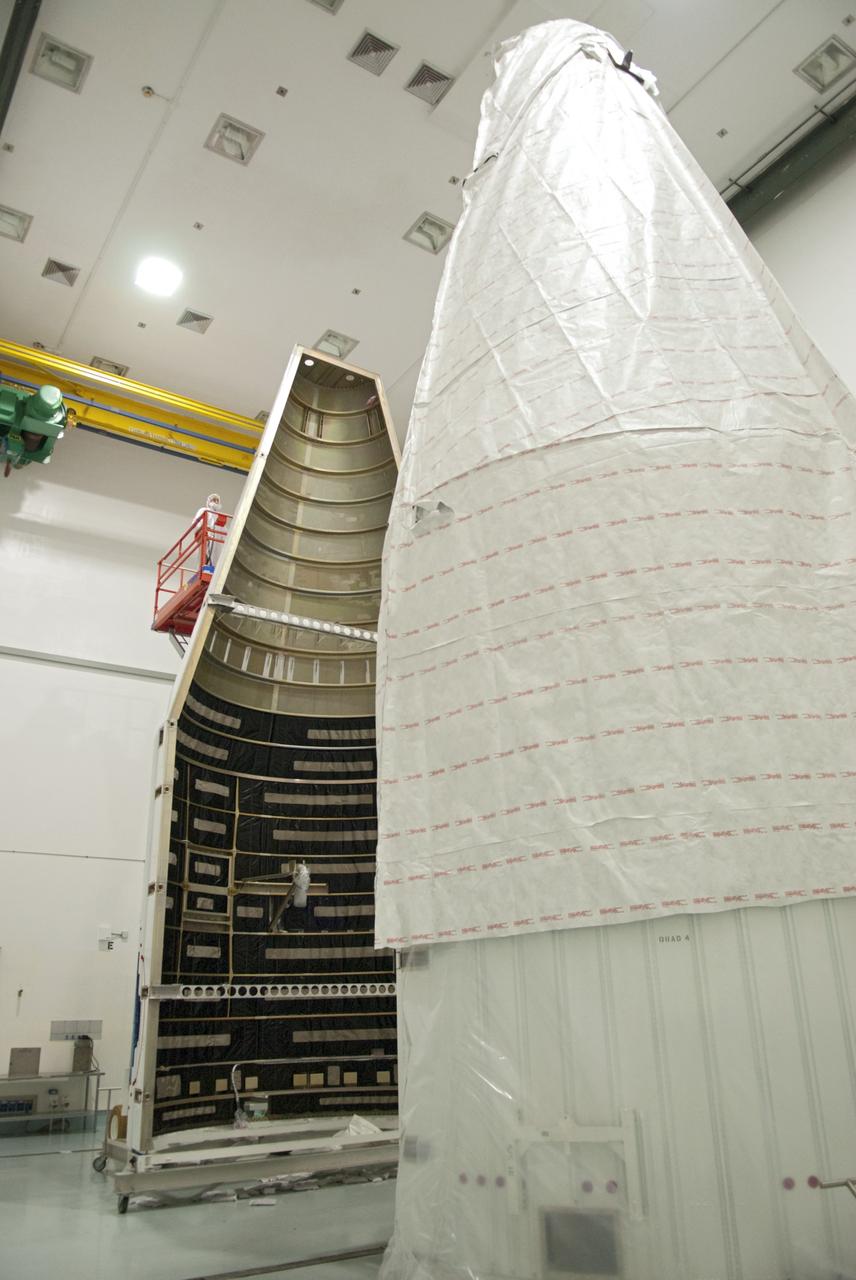 CAPE CANAVERAL, Fla. - Inside the Astrotech payload processing facility near NASA’s Kennedy Space Center in Florida, technicians inspect and prepare to uncover the nose cone fairing for the Radiation Belt Storm Probes, or RBSP, spacecraft. The nose faring will house and protect the RBSP during liftoff aboard an Atlas V rocket. NASA’s RBSP mission will help us understand the sun’s influence on Earth and near-Earth space by studying the Earth’s radiation belts on various scales of space and time. RBSP will begin its mission of exploration of Earth’s Van Allen radiation belts and the extremes of space weather after its liftoff aboard a United Launch Alliance Atlas V from Space Launch Complex 41 at Cape Canaveral Air Force Station, Fla. Liftoff is targeted for Aug. 23, 2012. For more information, visit http://www.nasa.gov/rbsp. Photo credit: NASA/Charisse Nahser