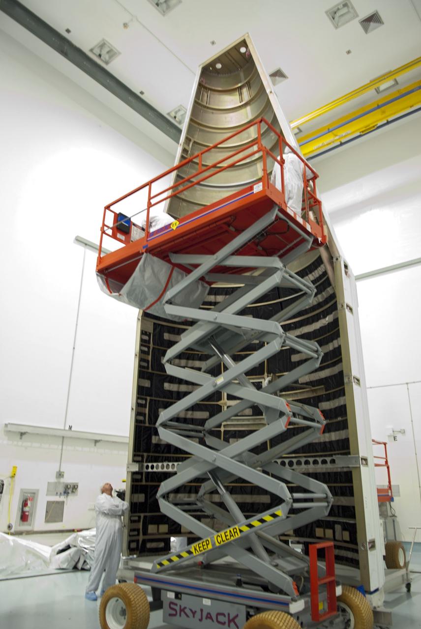 CAPE CANAVERAL, Fla. - Inside the Astrotech payload processing facility near NASA’s Kennedy Space Center in Florida, technicians use a lift to inspect the nose cone fairing for the Radiation Belt Storm Probes, or RBSP, spacecraft. The nose faring will house and protect the RBSP during liftoff aboard an Atlas V rocket. NASA’s RBSP mission will help us understand the sun’s influence on Earth and near-Earth space by studying the Earth’s radiation belts on various scales of space and time. RBSP will begin its mission of exploration of Earth’s Van Allen radiation belts and the extremes of space weather after its liftoff aboard a United Launch Alliance Atlas V from Space Launch Complex 41 at Cape Canaveral Air Force Station, Fla. Liftoff is targeted for Aug. 23, 2012. For more information, visit http://www.nasa.gov/rbsp. Photo credit: NASA/Charisse Nahser