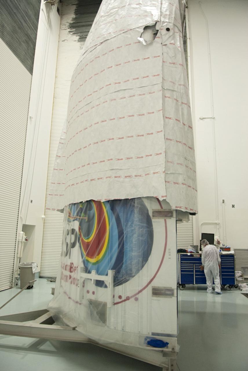 CAPE CANAVERAL, Fla. - Inside the Astrotech payload processing facility near NASA’s Kennedy Space Center in Florida, the nose cone fairing for the Radiation Belt Storm Probes, or RBSP, spacecraft is being uncovered for inspection. The nose faring will house and protect the RBSP during liftoff aboard an Atlas V rocket. NASA’s RBSP mission will help us understand the sun’s influence on Earth and near-Earth space by studying the Earth’s radiation belts on various scales of space and time. RBSP will begin its mission of exploration of Earth’s Van Allen radiation belts and the extremes of space weather after its liftoff aboard a United Launch Alliance Atlas V from Space Launch Complex 41 at Cape Canaveral Air Force Station, Fla. Liftoff is targeted for Aug. 23, 2012. For more information, visit http://www.nasa.gov/rbsp. Photo credit: NASA/Charisse Nahser