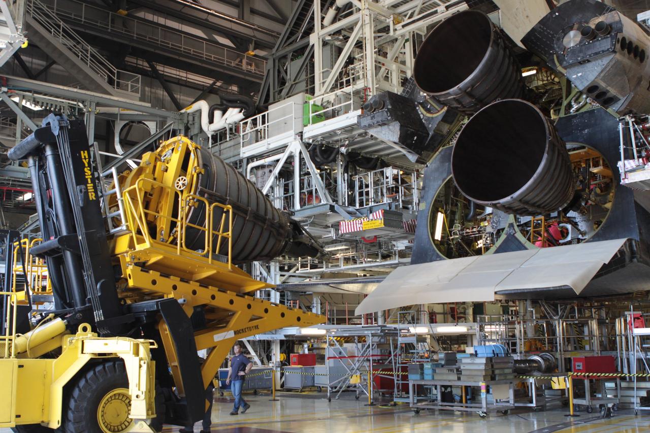 CAPE CANAVERAL, Fla. – Inside Orbiter Processing Facility-2 at NASA’s Kennedy Space Center in Florida, a Hyster forklift carries replica shuttle main engine 2, or RSME 2, for installation on space shuttle Endeavour. The orbiter is surrounded by work platforms allowing access to all areas of the spacecraft. The work is part of Transition and Retirement of the remaining space shuttles, Endeavour and Atlantis. Endeavour is being prepared for public display at the California Science Center in Los Angeles. Its ferry flight to California is targeted for mid-September. Endeavour was the last space shuttle added to NASA’s orbiter fleet. Over the course of its 19-year career, Endeavour spent 299 days in space during 25 missions. For more information, visit http://www.nasa.gov/shuttle. Photo credit: NASA/David Lee