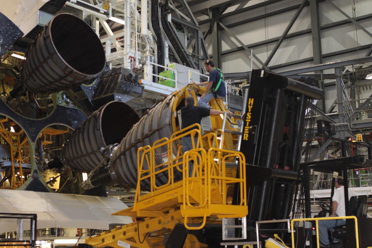 CAPE CANAVERAL, Fla. – Inside Orbiter Processing Facility-2 at NASA’s Kennedy Space Center in Florida, United Space Alliance technicians on a Hyster forklift move replica shuttle main engine 2, or RSME 2, closer for installation on space shuttle Endeavour. The orbiter is surrounded by work platforms allowing access to all areas of the spacecraft. The work is part of Transition and Retirement of the remaining space shuttles, Endeavour and Atlantis. Endeavour is being prepared for public display at the California Science Center in Los Angeles. Its ferry flight to California is targeted for mid-September. Endeavour was the last space shuttle added to NASA’s orbiter fleet. Over the course of its 19-year career, Endeavour spent 299 days in space during 25 missions. For more information, visit http://www.nasa.gov/shuttle. Photo credit: NASA/David Lee